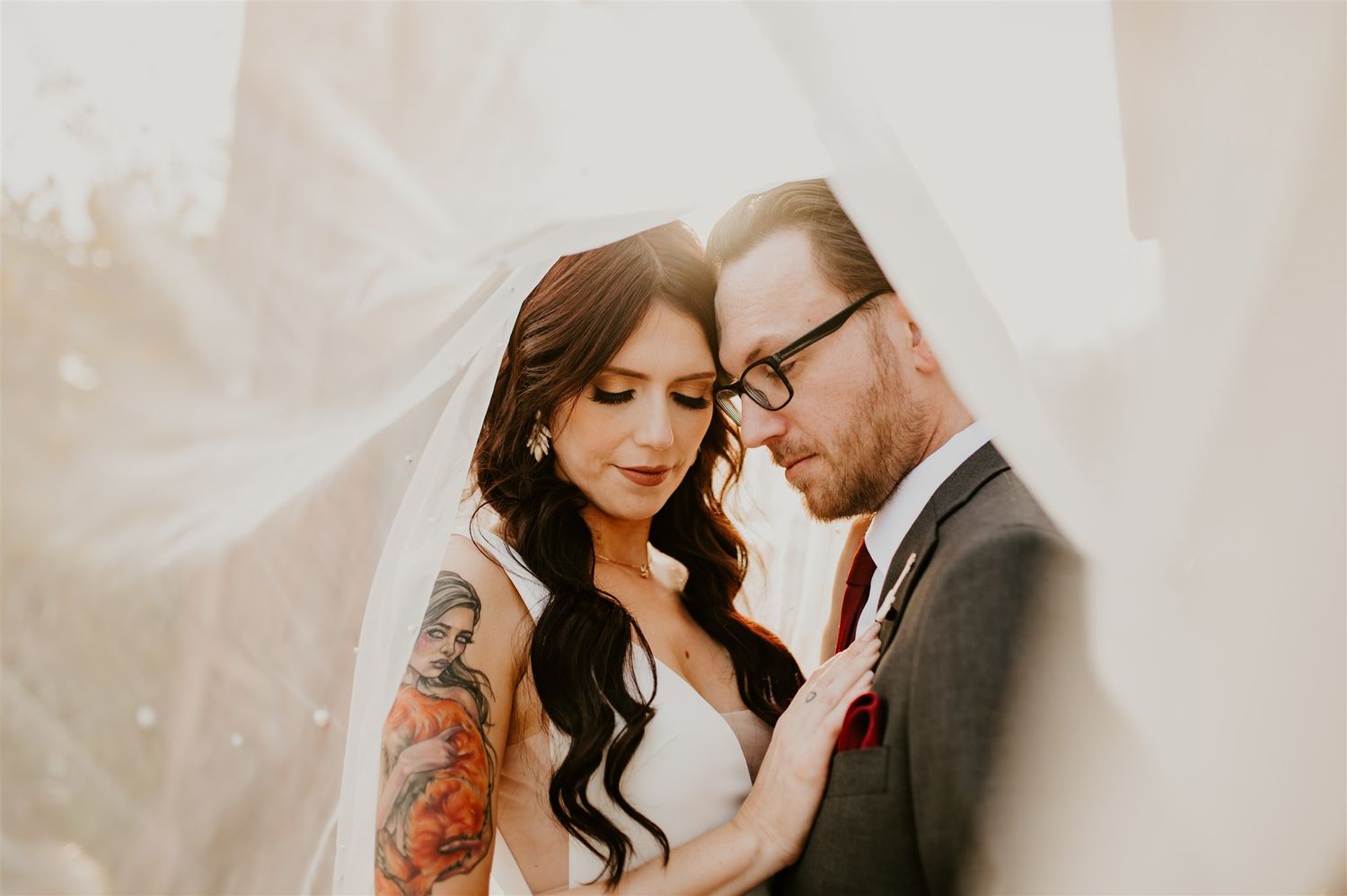 Intimate wedding portrait with soft lighting and delicate veil details.
