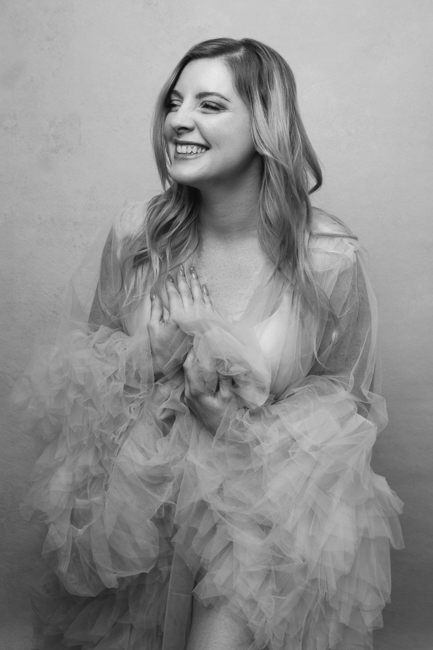 Artistic black and white portraits featuring a feminine figure in ruffled tulle.