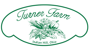 Green oval logo for Turner Farm in Hudson Hill, Ohio with floral design elements.