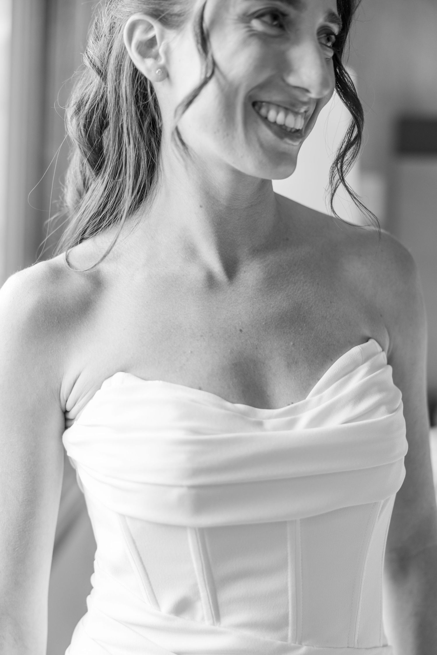 A black and white collage of four photos showing a bride in an elegant off-shoulder wedding dress.