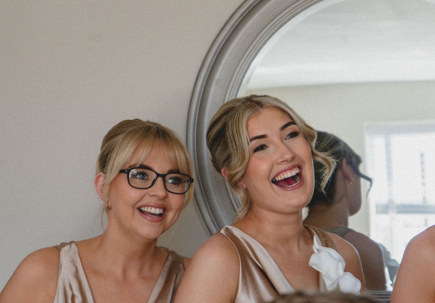 Bridesmaid sharing a joyful moment with a loved one during wedding preparations, captured by luxury wedding content creator Unveil by Hollie