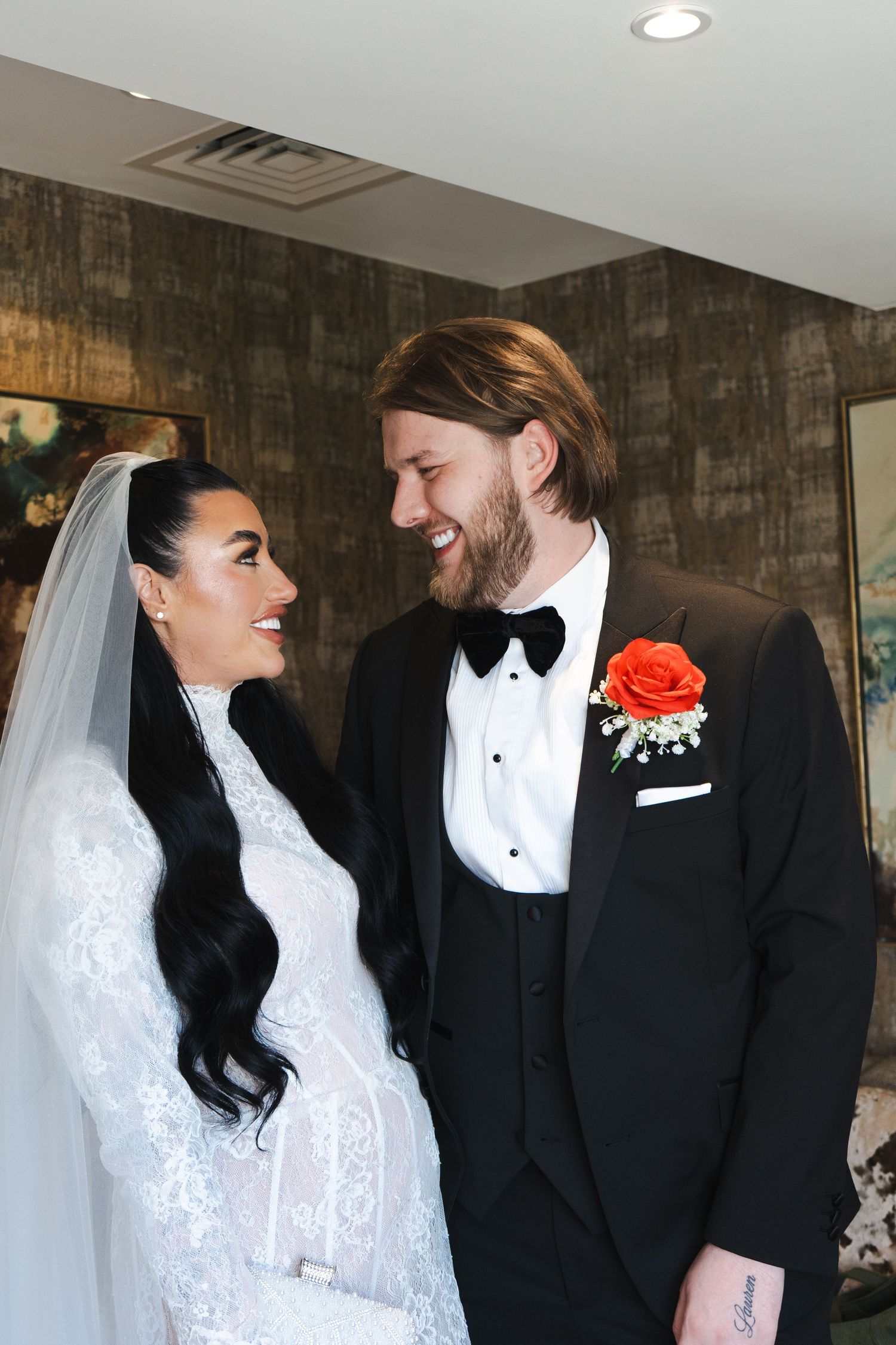 Bride and groom sharing a joyful moment during wedding morning preparations, captured by luxury wedding content creator Unveil by Hollie