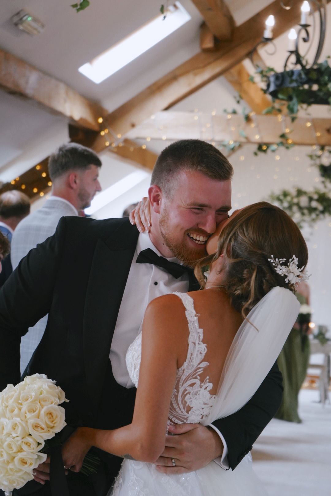 newlyweds hugging at the end of aisle