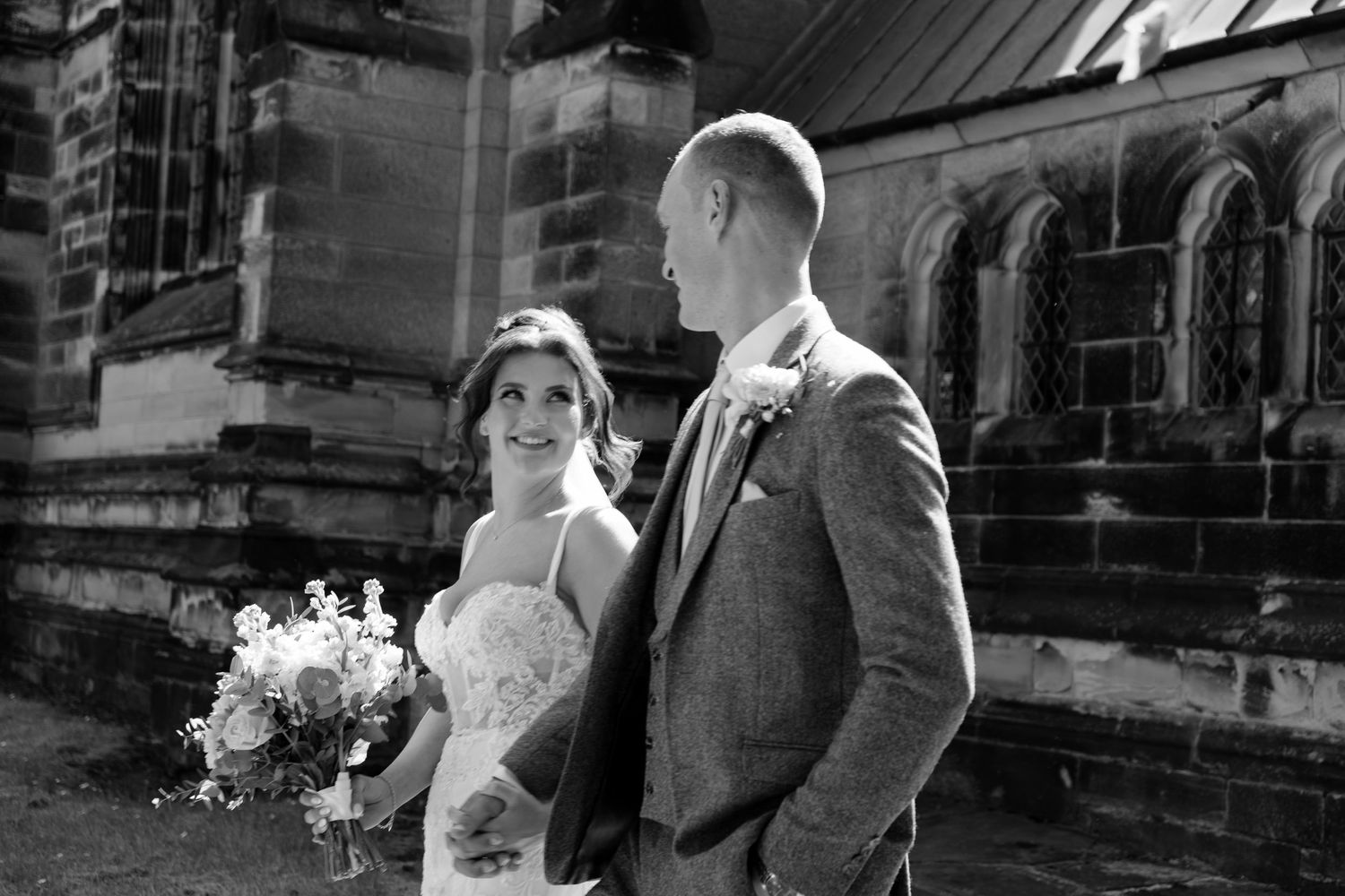 Bride and groom sharing a candid moment outside their wedding venue, captured by luxury wedding content creator Unveil by Hollie