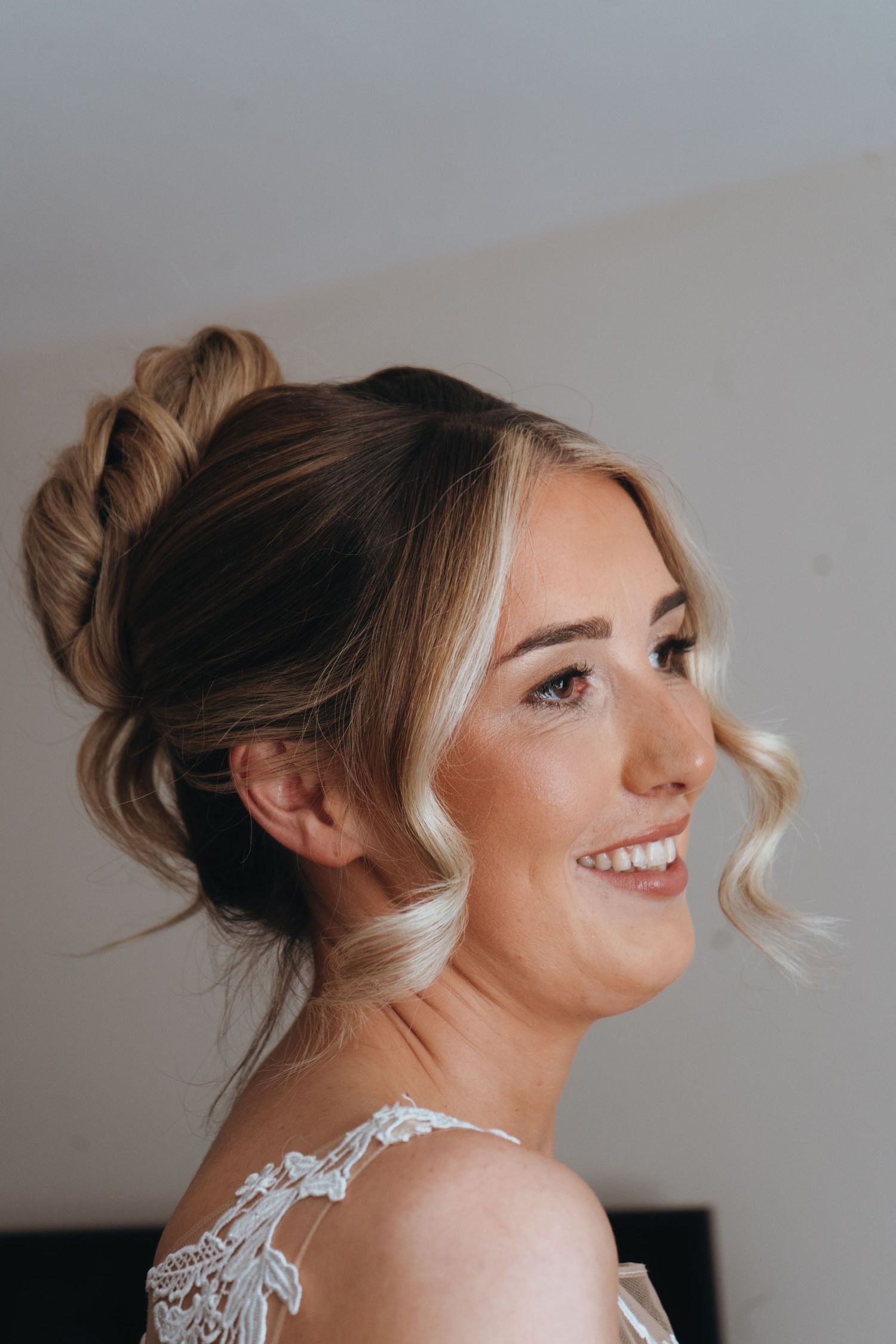 Bride smiling during wedding morning preparations, captured by luxury wedding content creator Unveil by Hollie