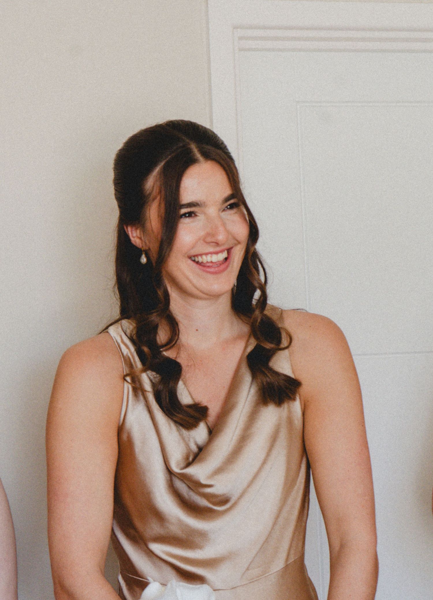 Bridesmaid smiling during wedding morning preparations, captured by luxury wedding content creator Unveil by Hollie