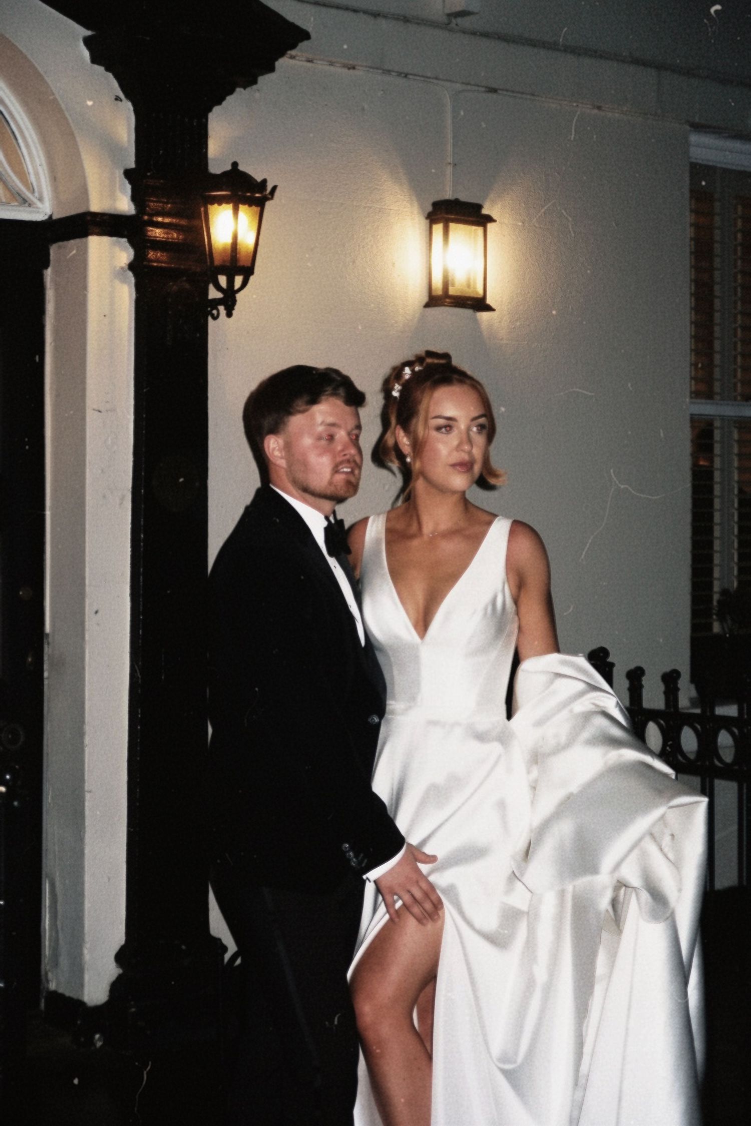 Bride and groom sharing an elegant evening portrait outside their wedding venue, captured by luxury wedding content creator Unveil by Hollie
