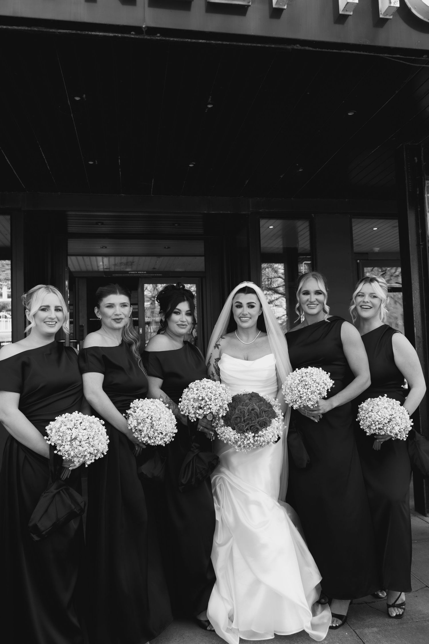 Bride posing with her bridesmaids outside the wedding venue, captured by luxury wedding content creator Unveil by Hollie