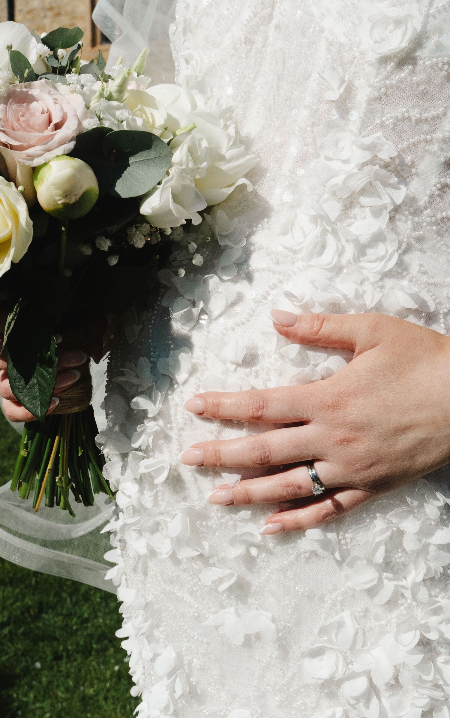 Bride's wedding ring and bouquet details captured against a bridal gown, photographed by luxury wedding content creator Unveil by Hollie