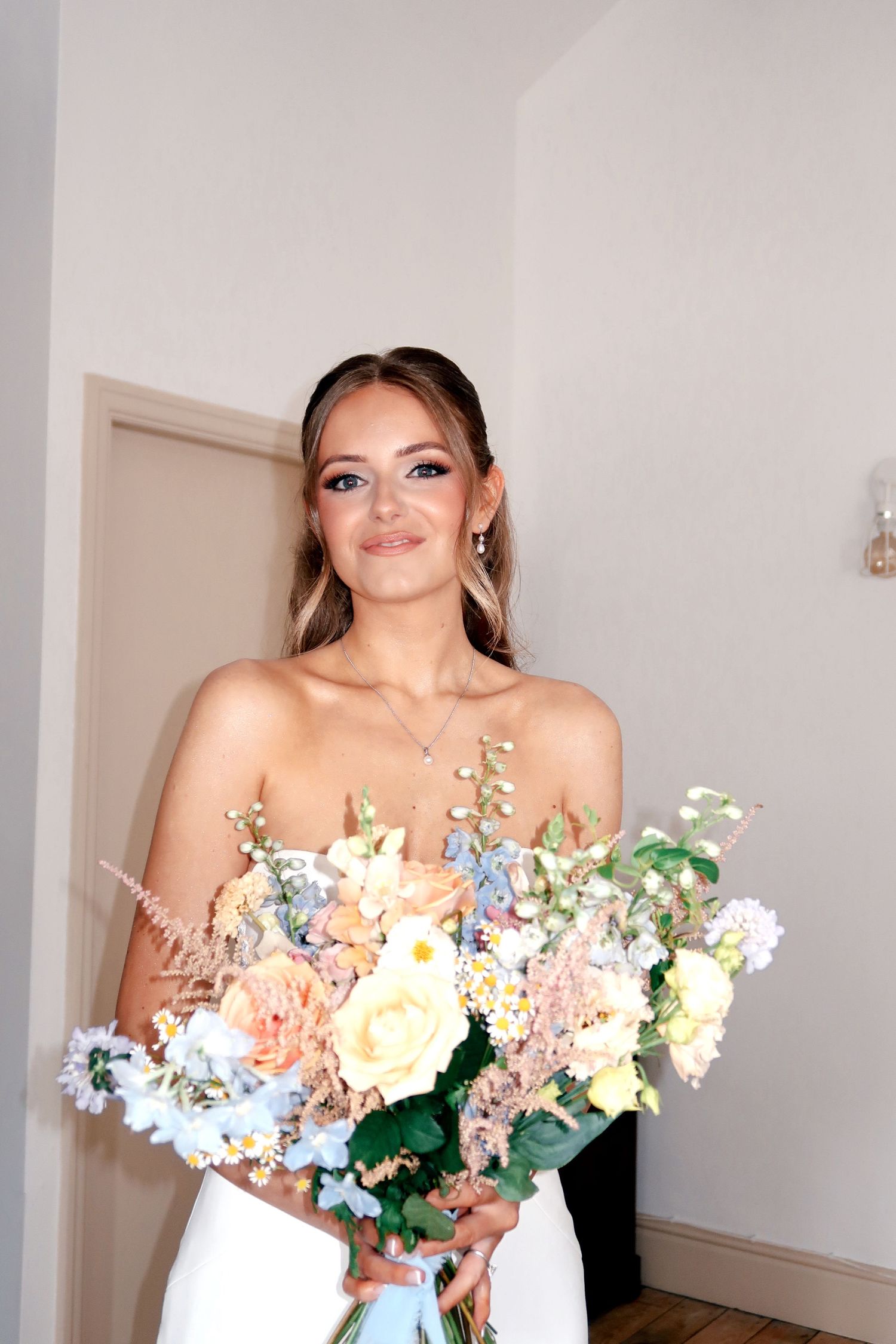 Bride holding her wedding bouquet during bridal preparations, captured by luxury wedding content creator Unveil by Hollie