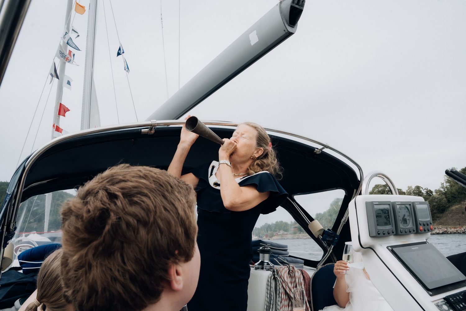 Wedding guests boarding a sailboat at a marina during a nautical wedding celebration.