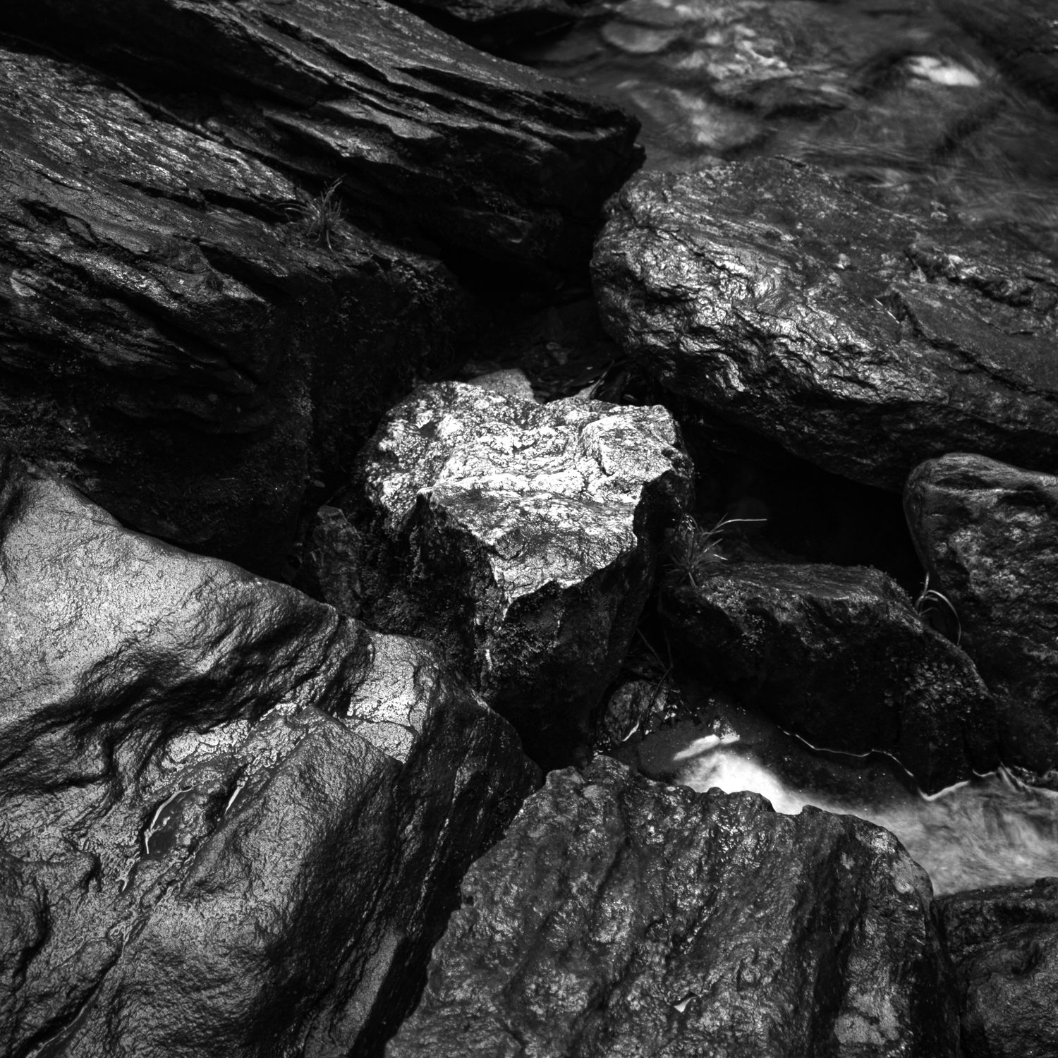 black and white close up wet rocks stream intimate nature macro fine art print