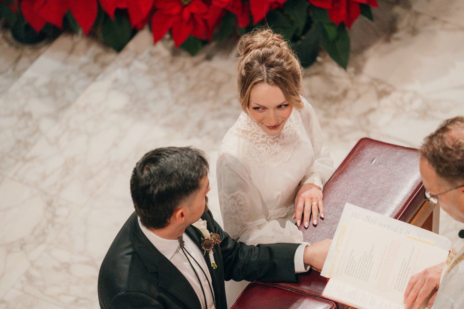 Bride and groom signing the marriage register at the altar