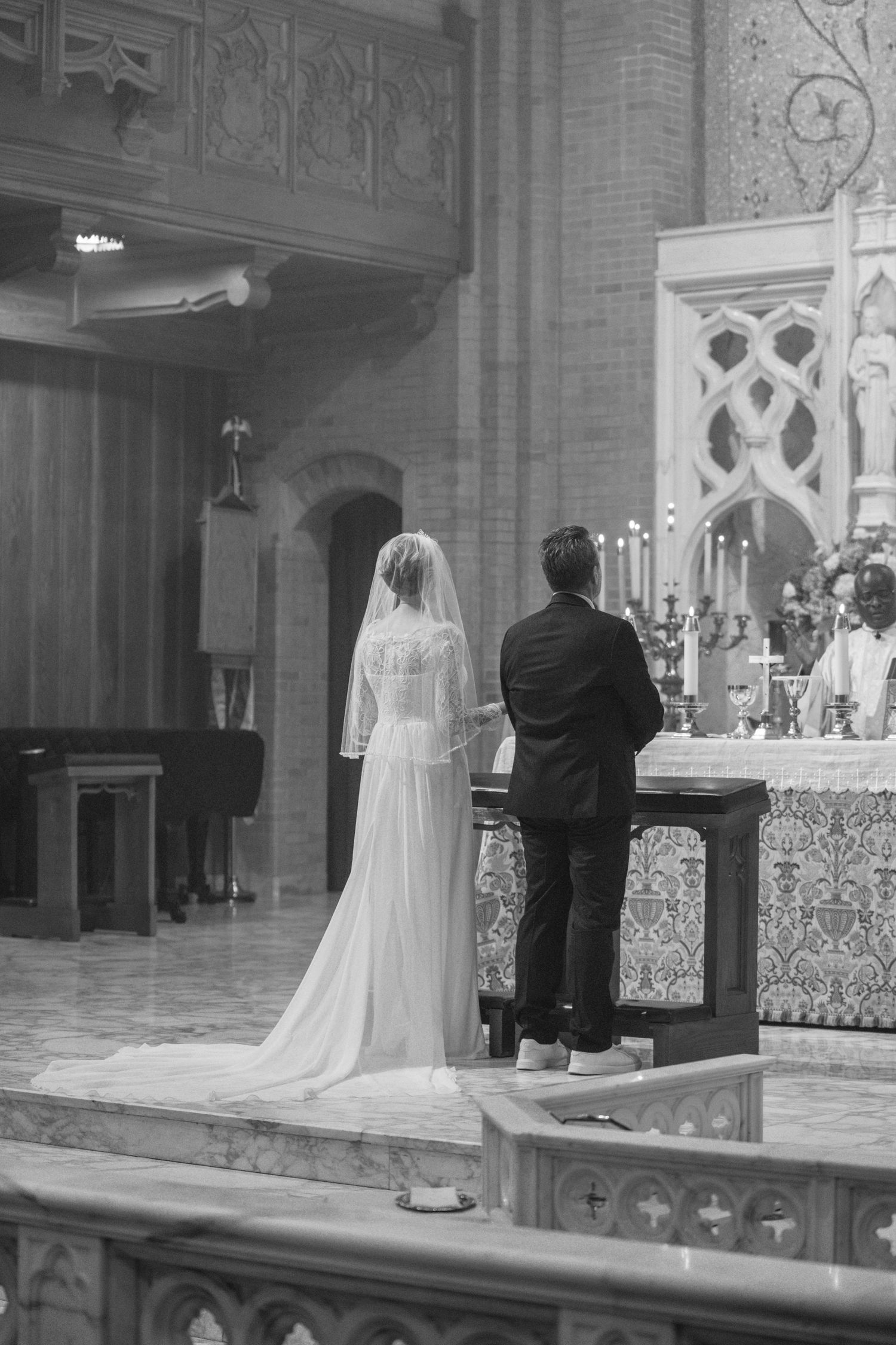 Bride and groom standing before the altar during their Catholic wedding