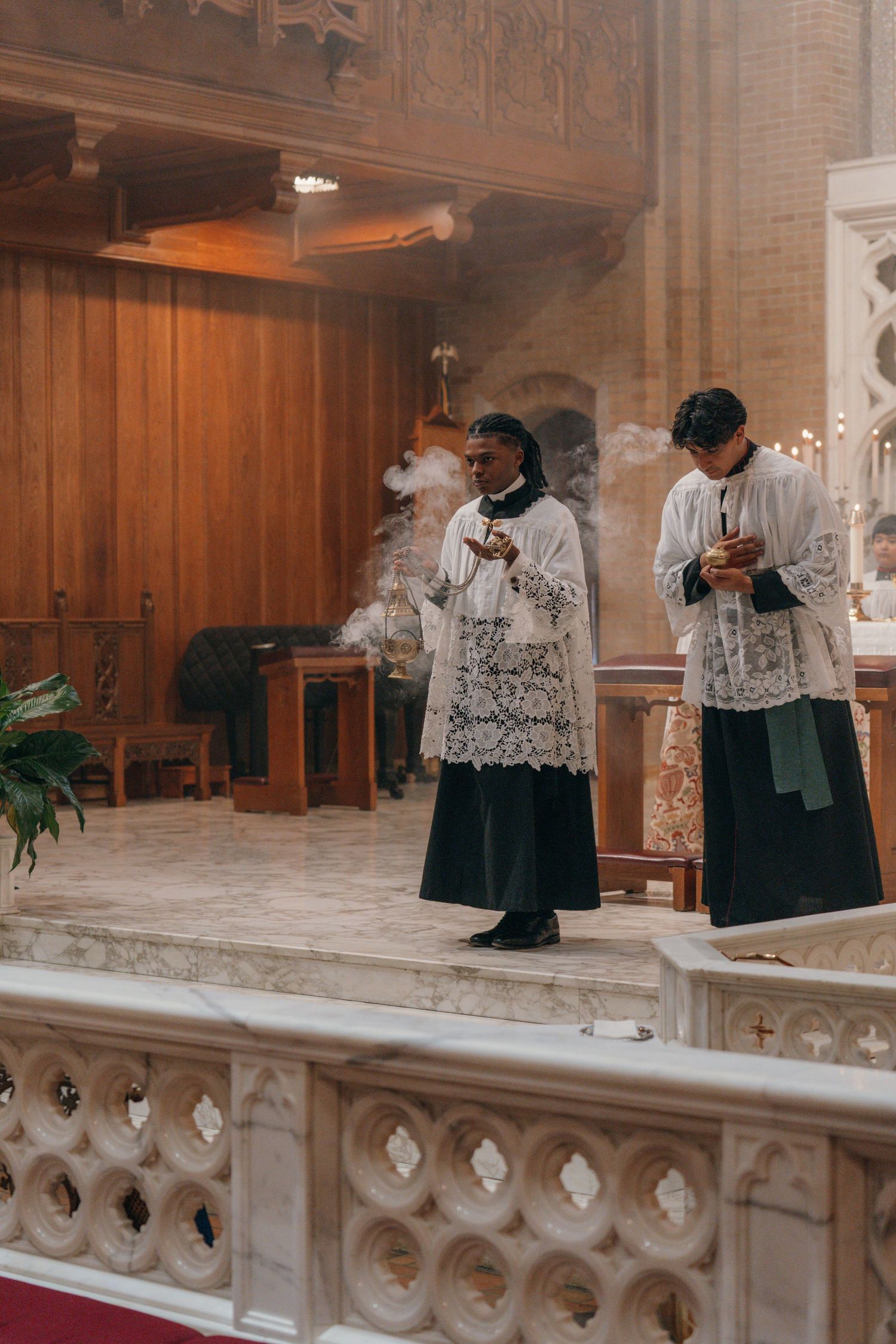 Altar servers in cassocks and surplices assisting at a Nuptial Mass