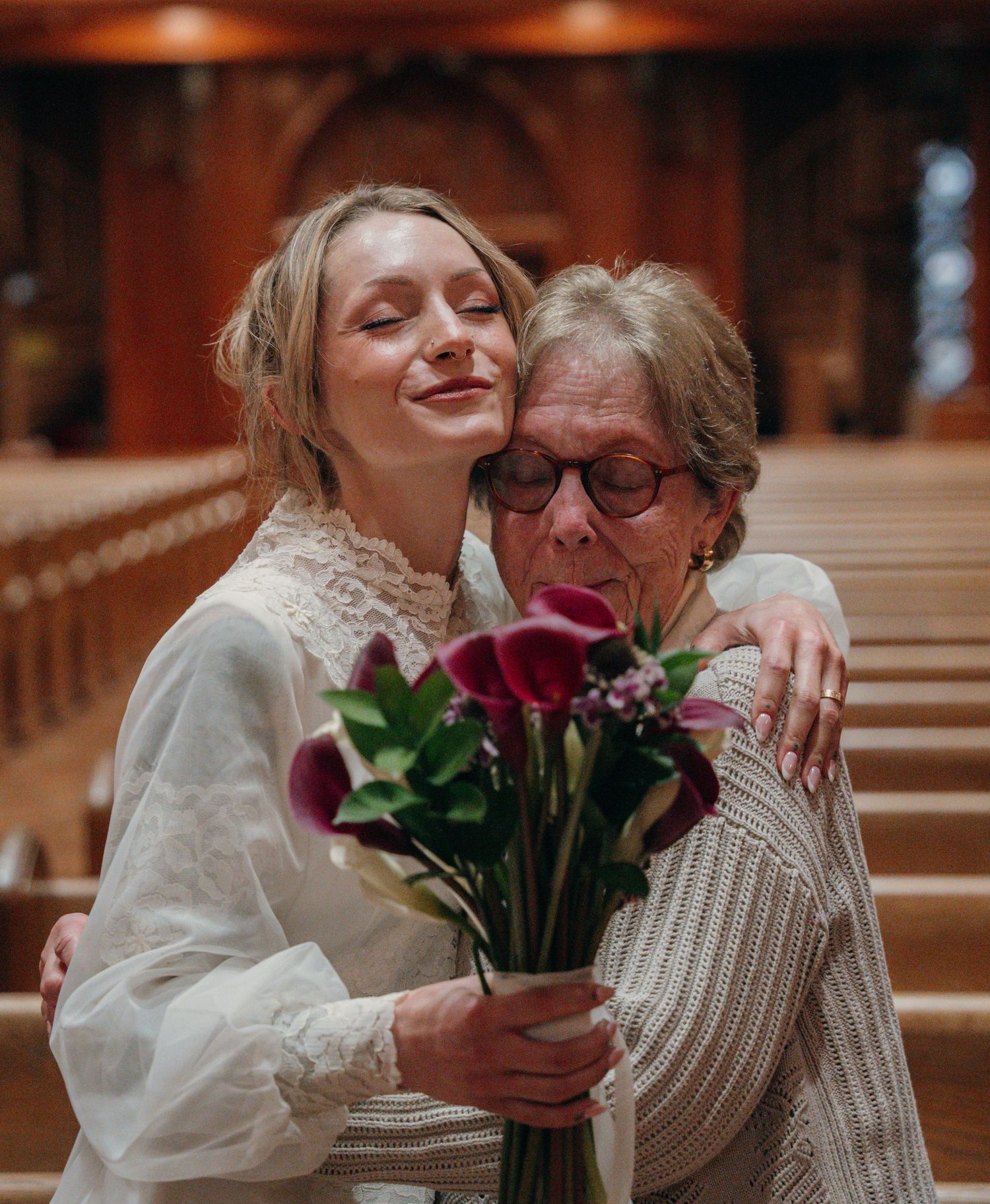 Bride sharing a tender hug with her grandmother after the wedding
