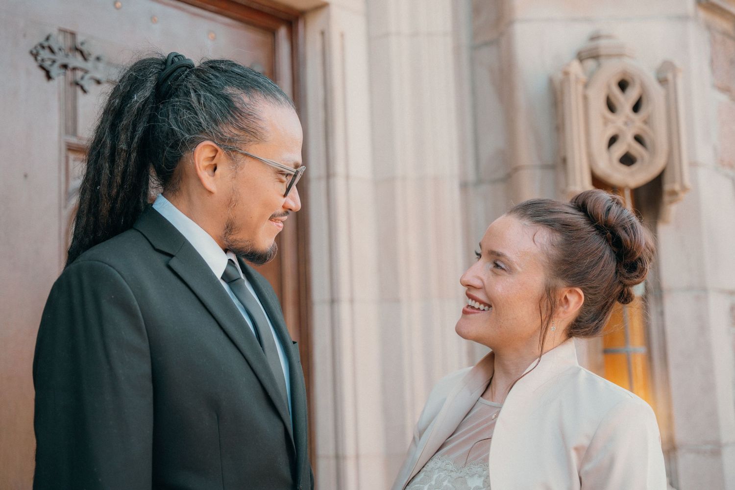 Bride and groom sharing a smile at the church doors after their ceremony
