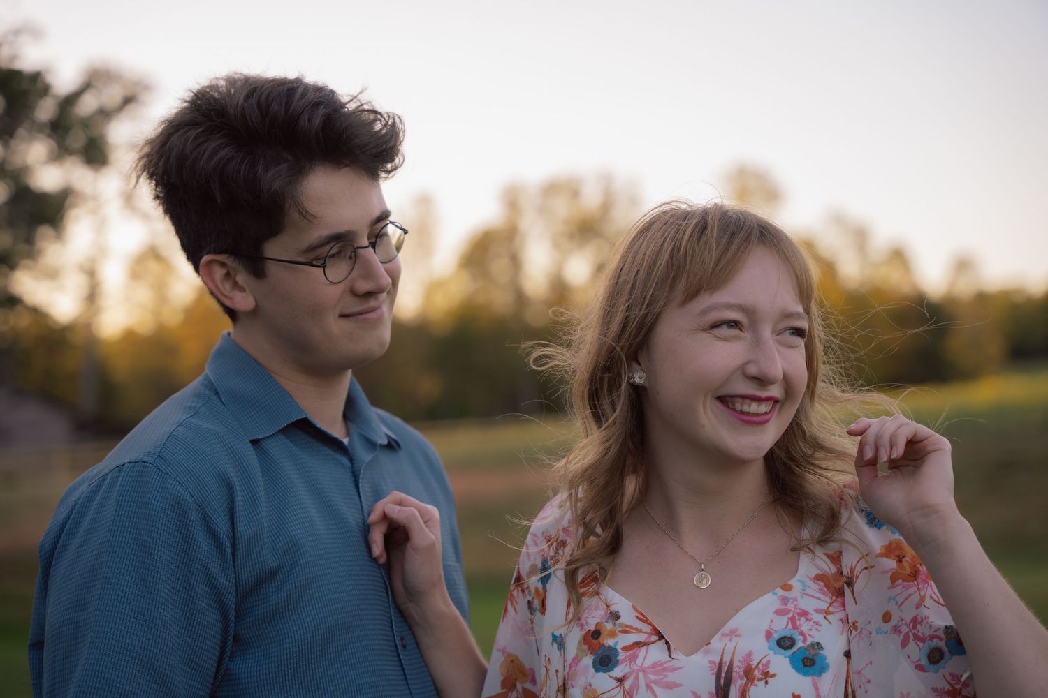 Couple laughing together during a golden hour engagement session