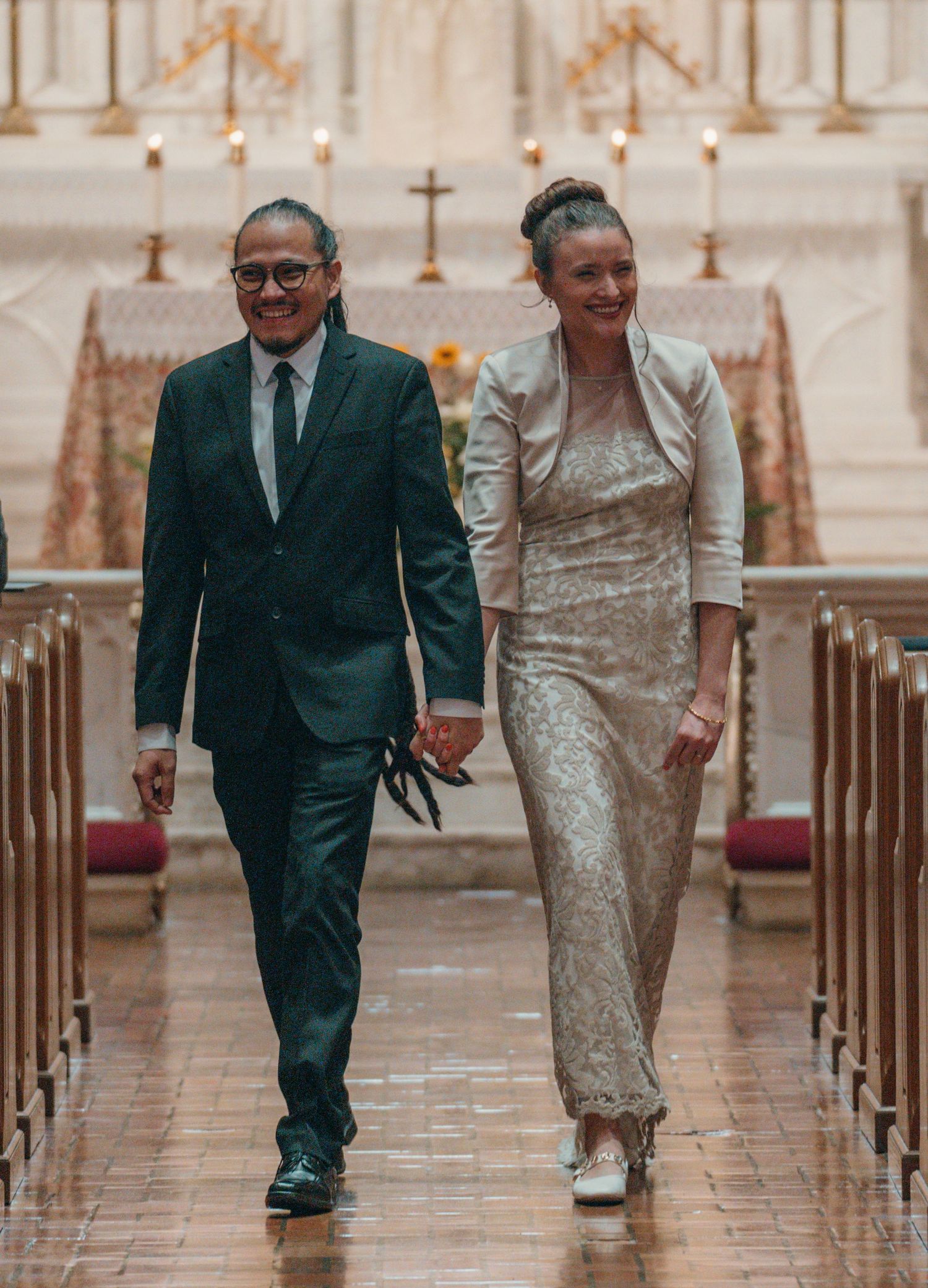 Newlyweds walking down the aisle of a Catholic church after the wedding Mass