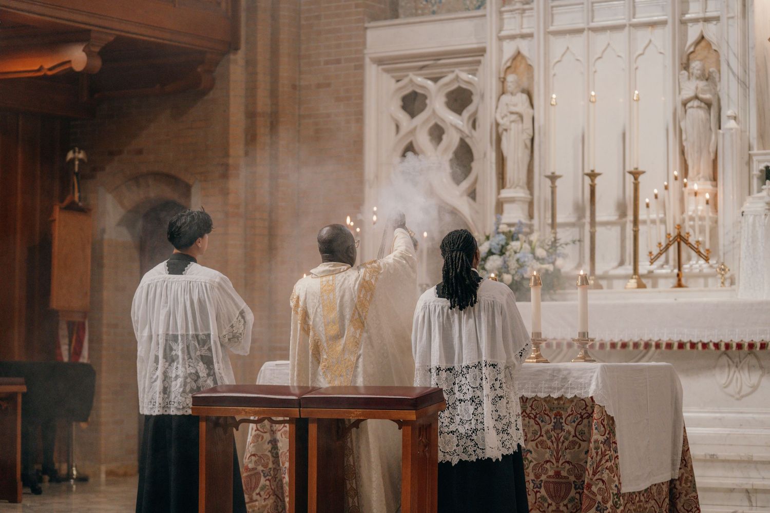 Altar servers processing to the altar at the start of the wedding Mass