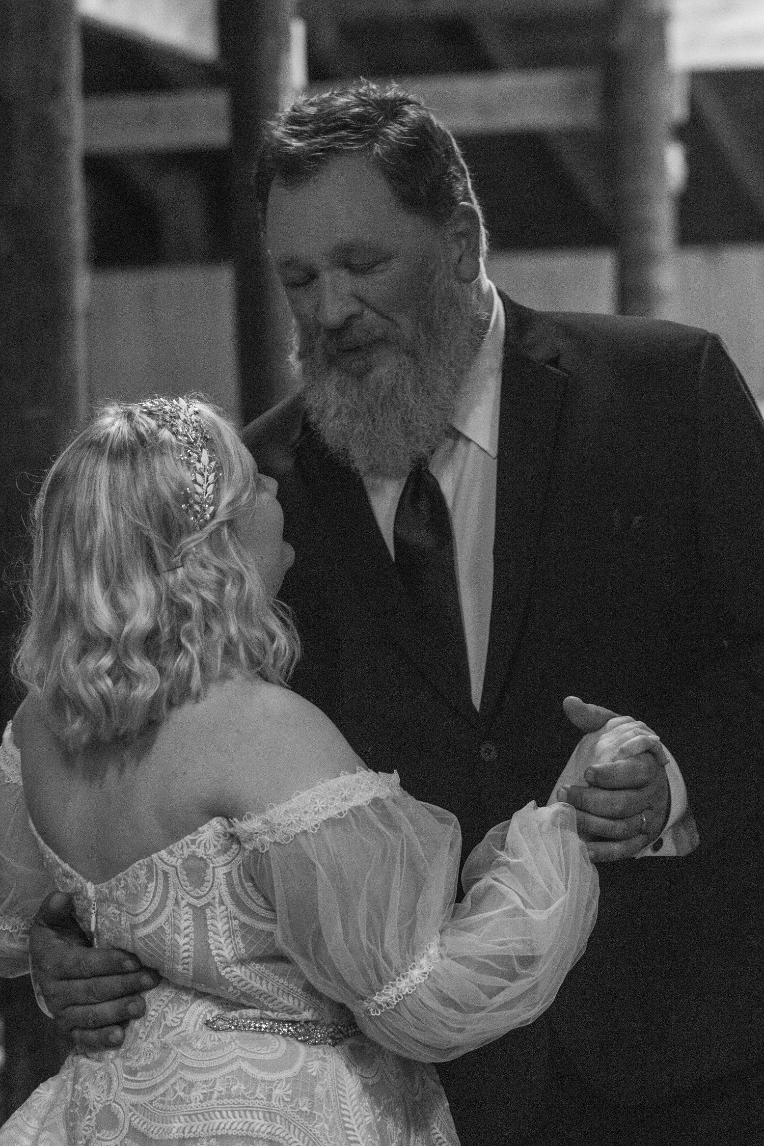 Black and white photo of the bride dancing with her father at the reception