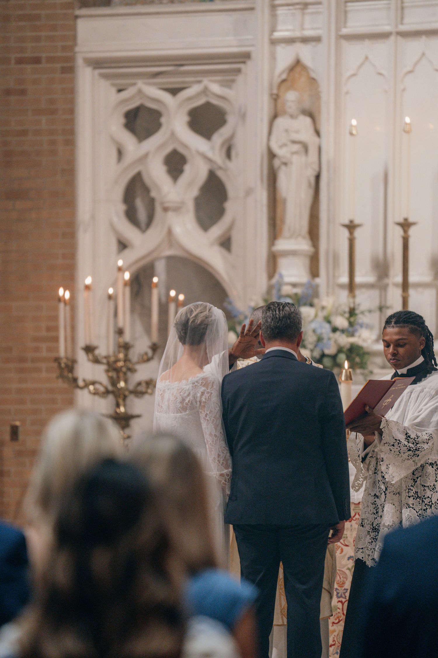 Bride and groom at the altar as the priest leads the wedding liturgy