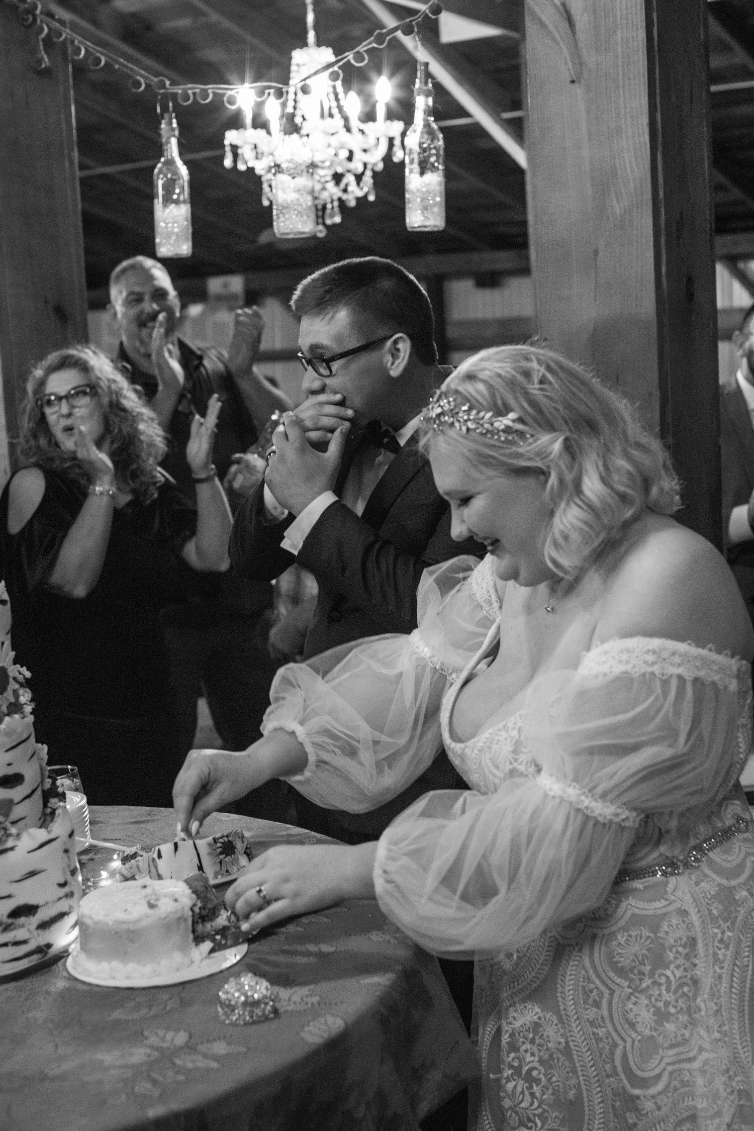 Black and white photo of the bride and groom cutting their wedding cake