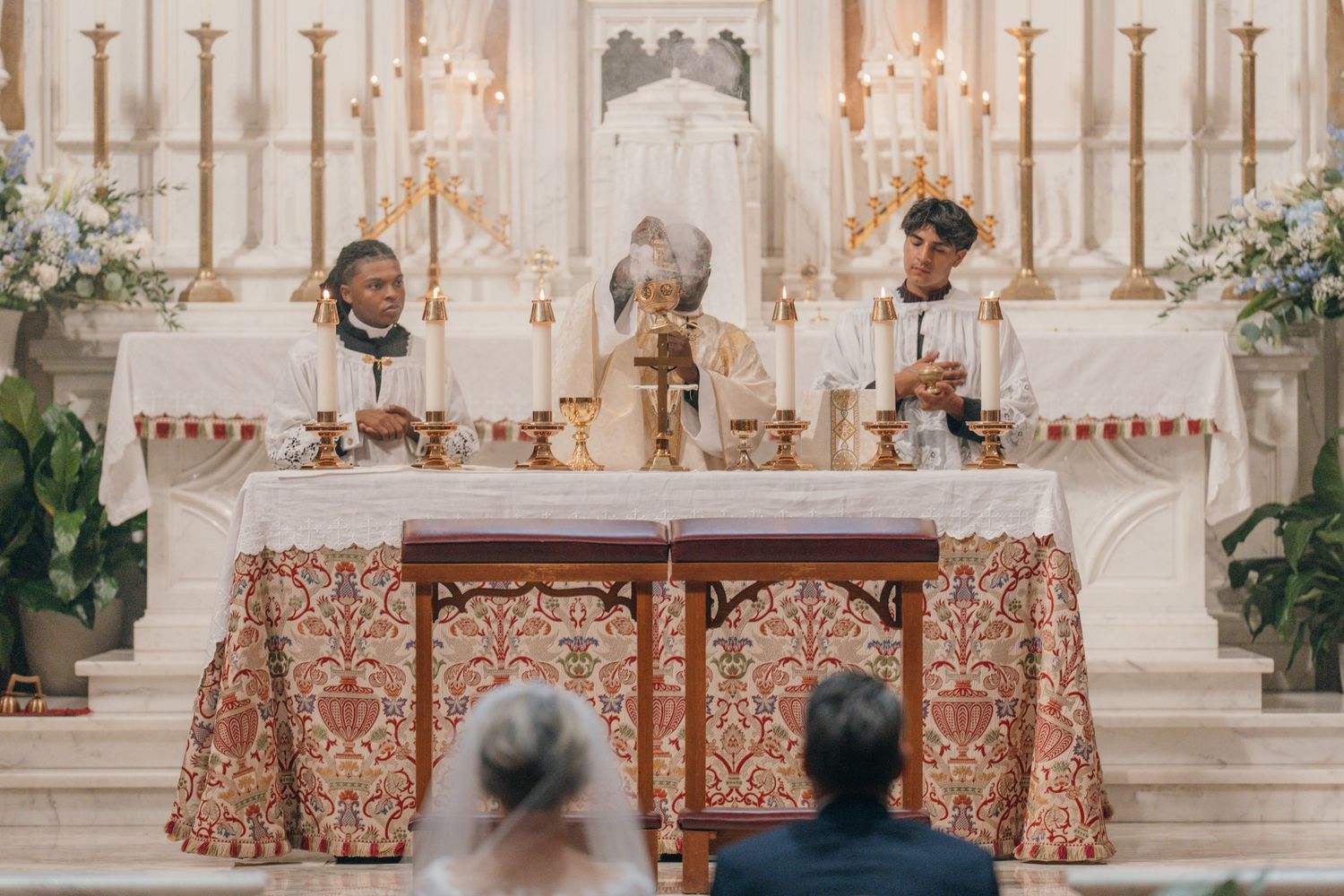 Priests and altar servers at the high altar during a Nuptial Mass