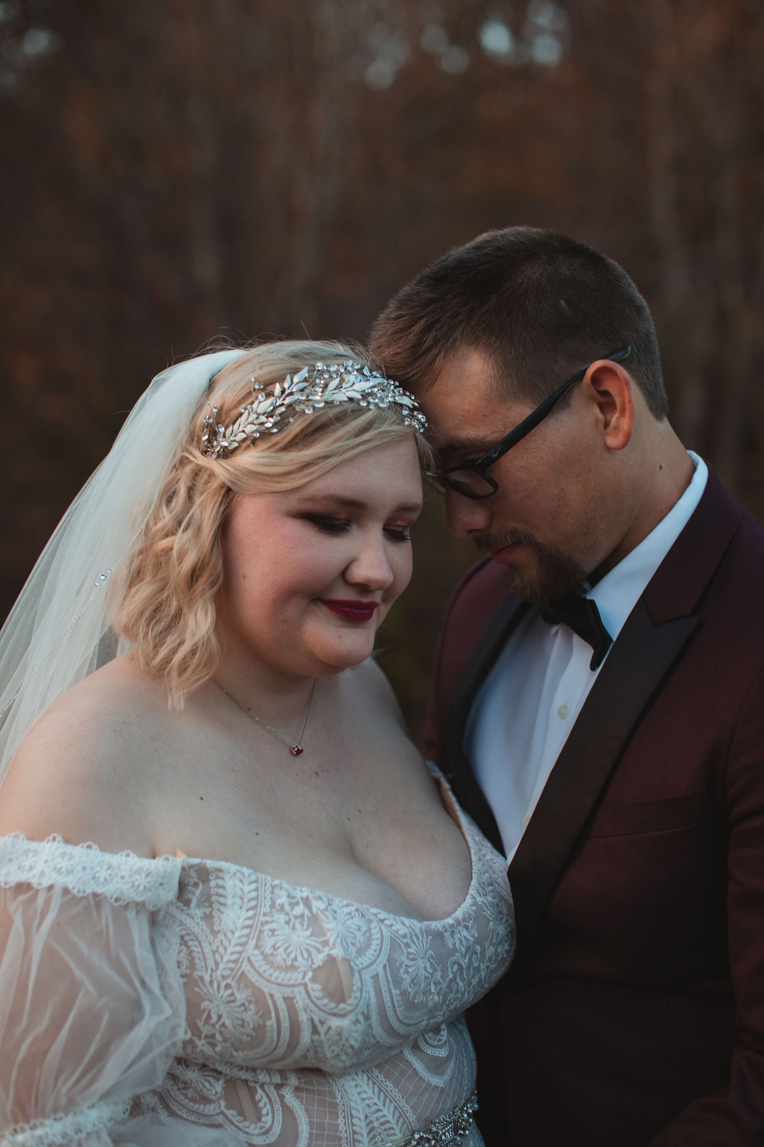 Groom resting his forehead against the bride's in an intimate wedding portrait