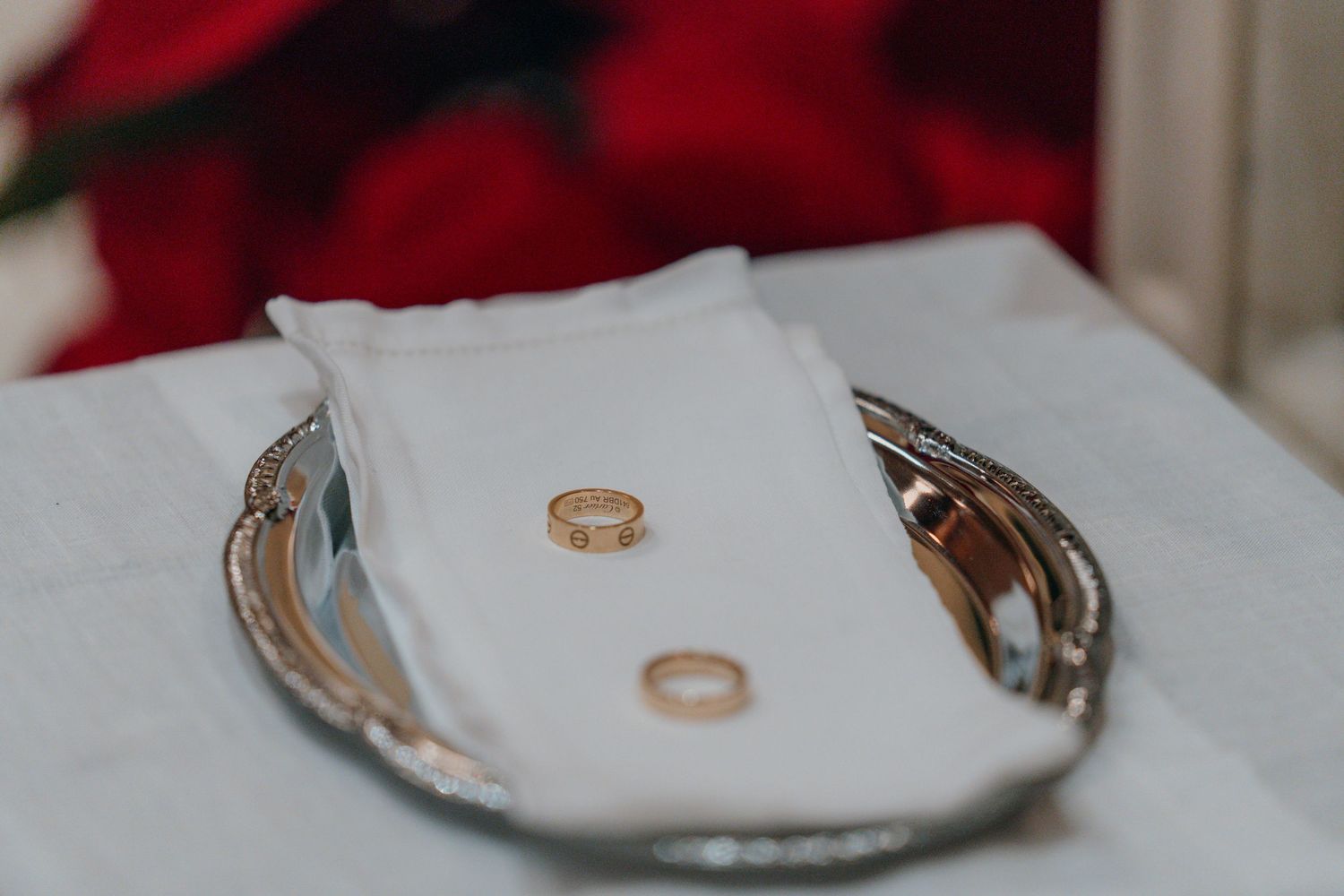 Wedding rings on a silver tray waiting to be blessed at the altar