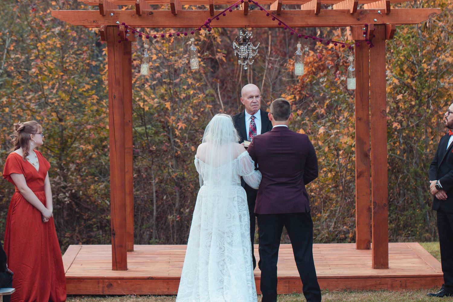 Back view of the couple at the altar during an outdoor fall ceremony