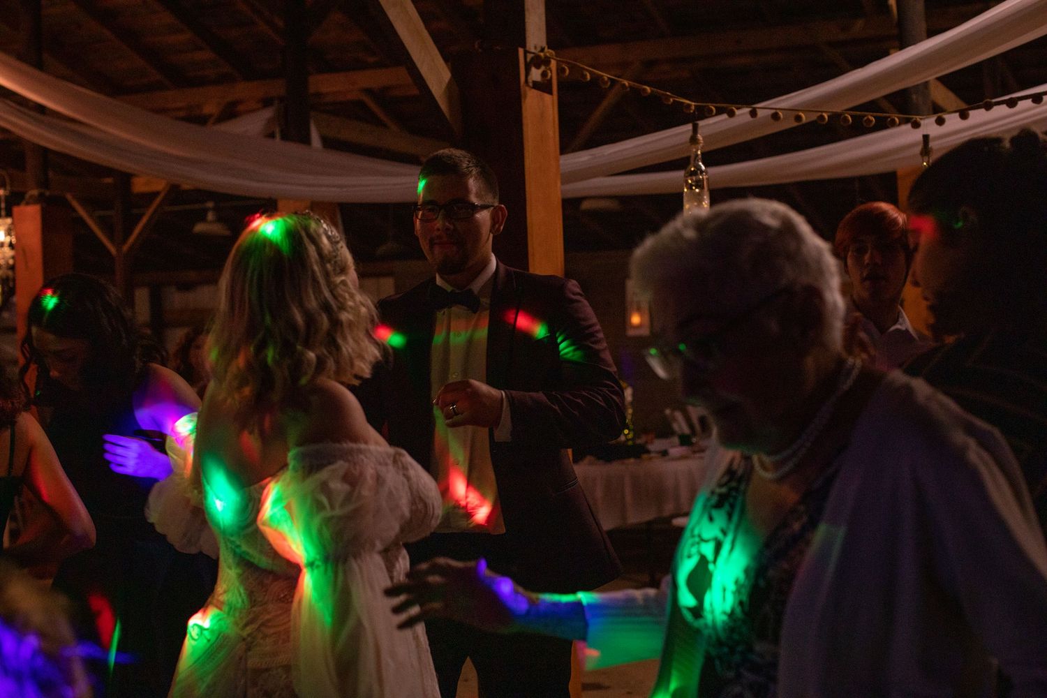 Reception dance floor glowing with green and purple party lights