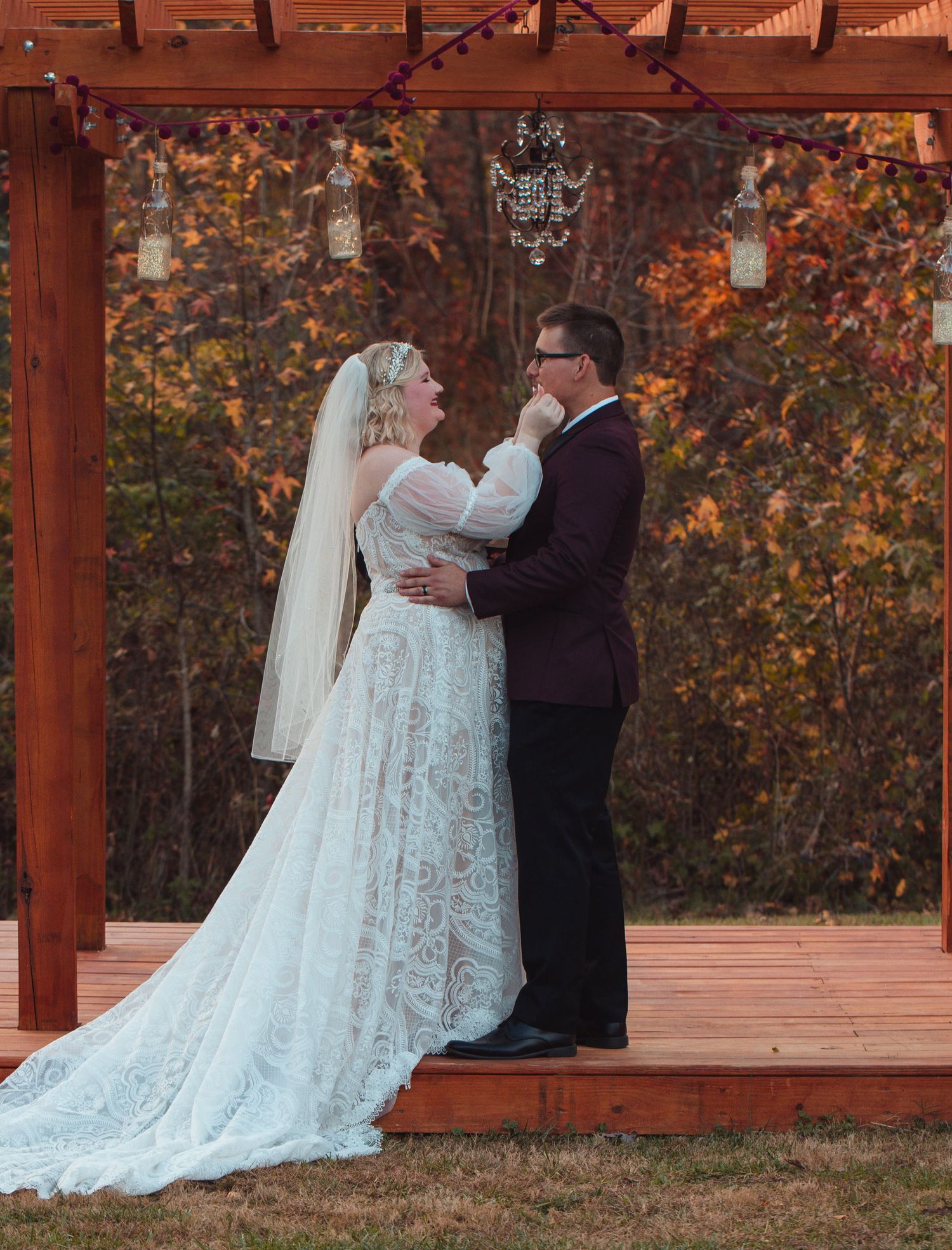 Groom seeing his bride at the altar under a wooden pergola