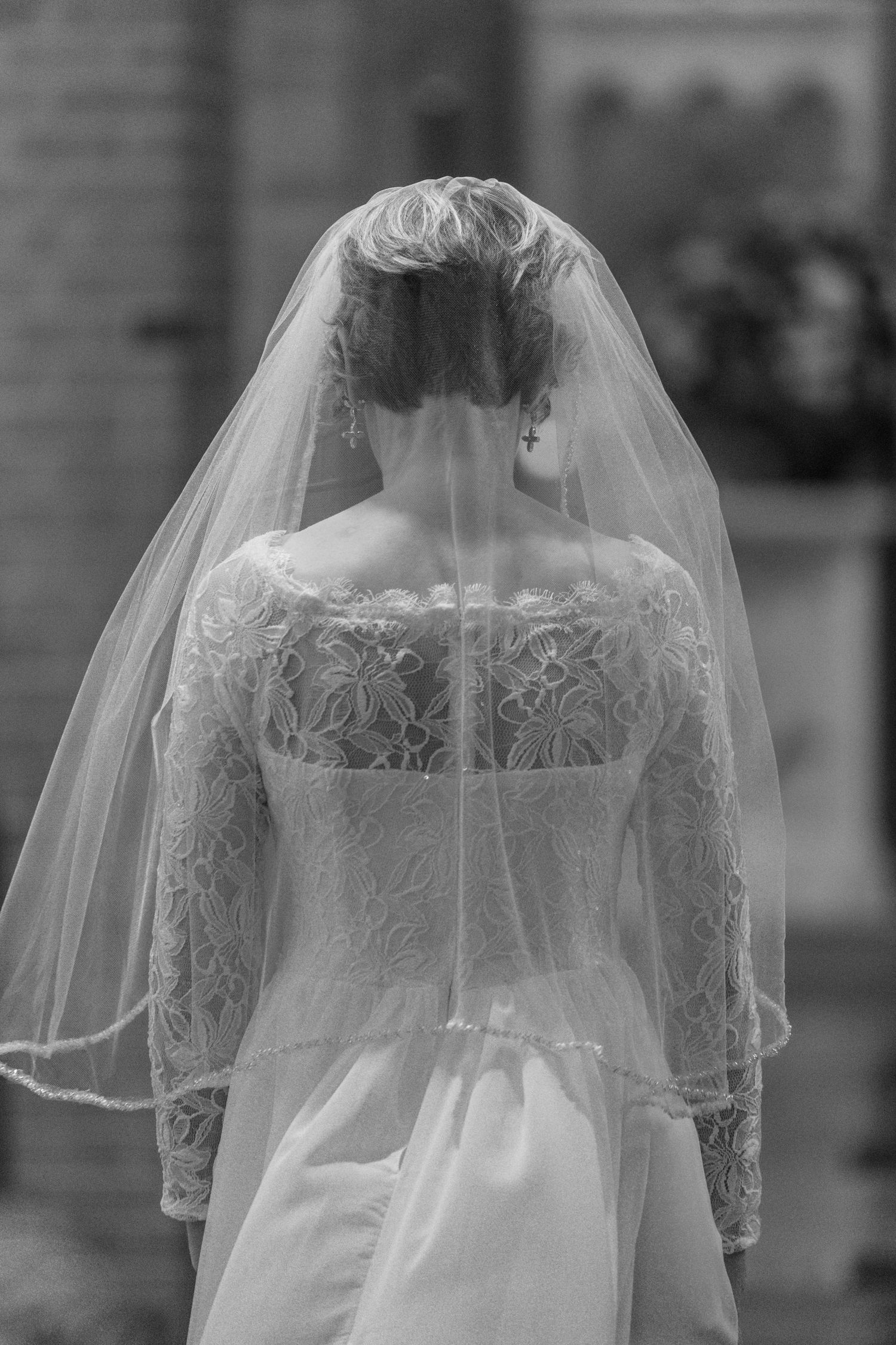 Black and white photo of the bride's veil and lace back