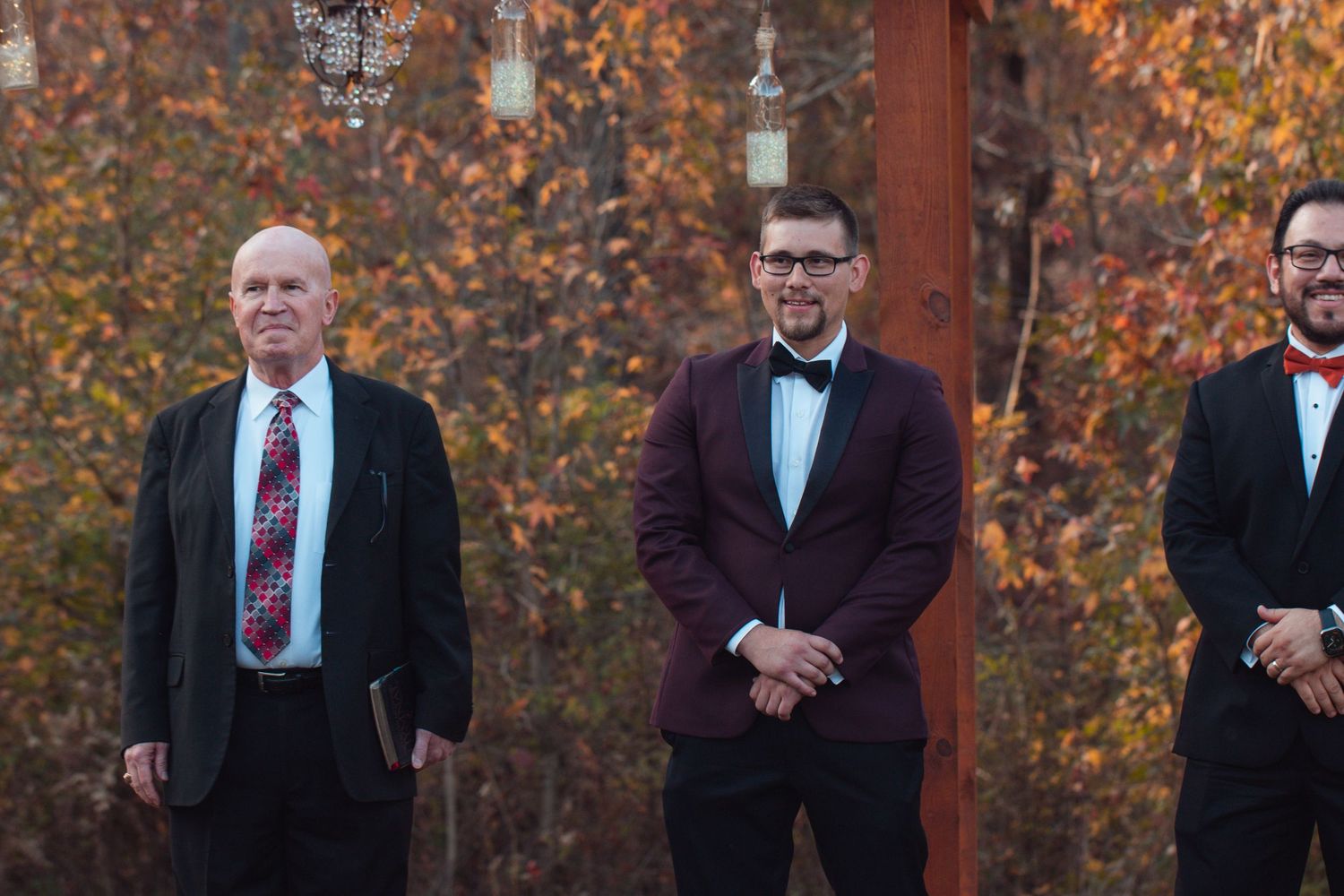Groom waiting at the altar with his officiant and groomsmen