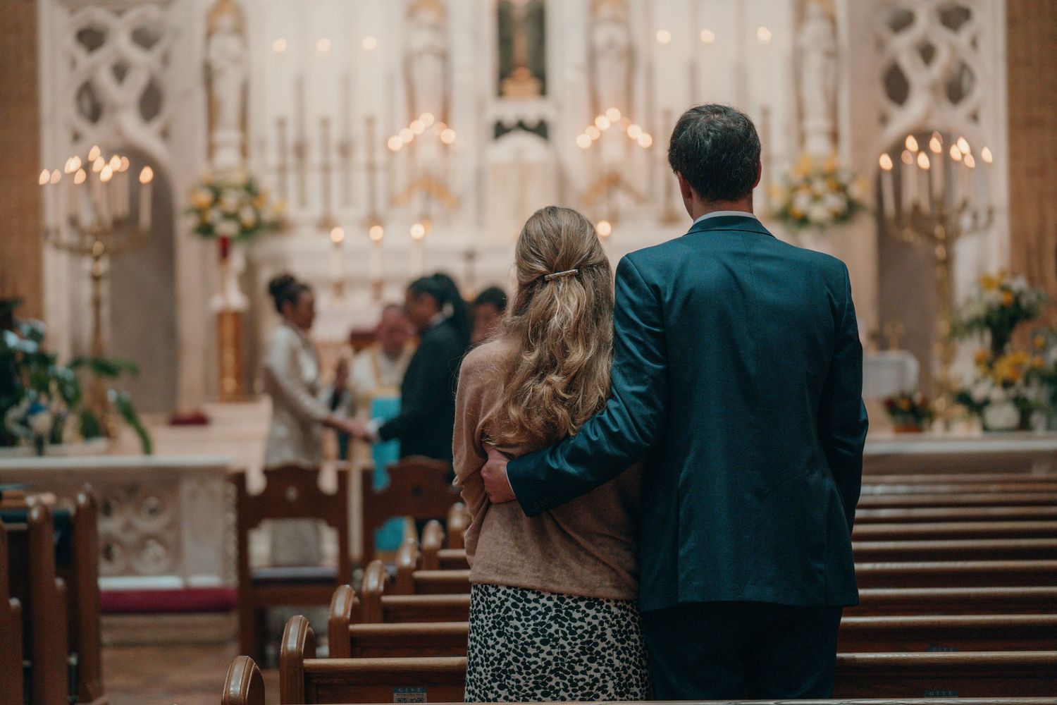 Couple standing before the altar in a Catholic church during their wedding