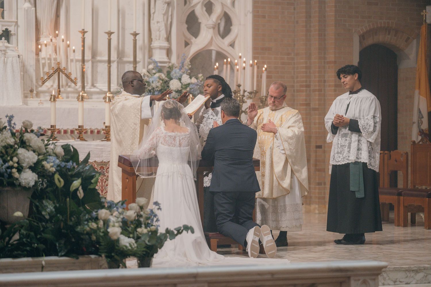 Priest and altar servers with the bride and groom at the altar during Mass