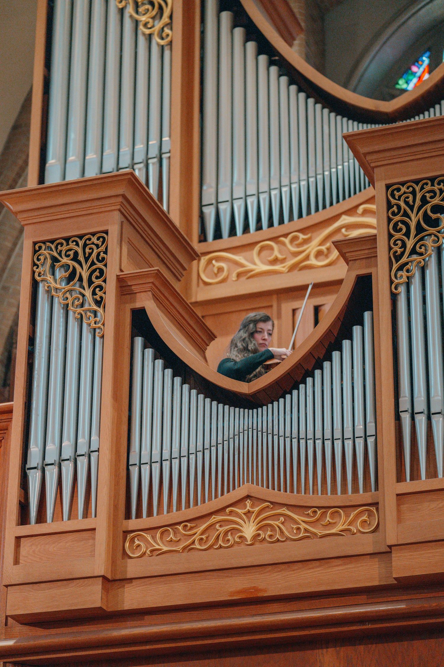 Wooden pipe organ with silver pipes in a Catholic church