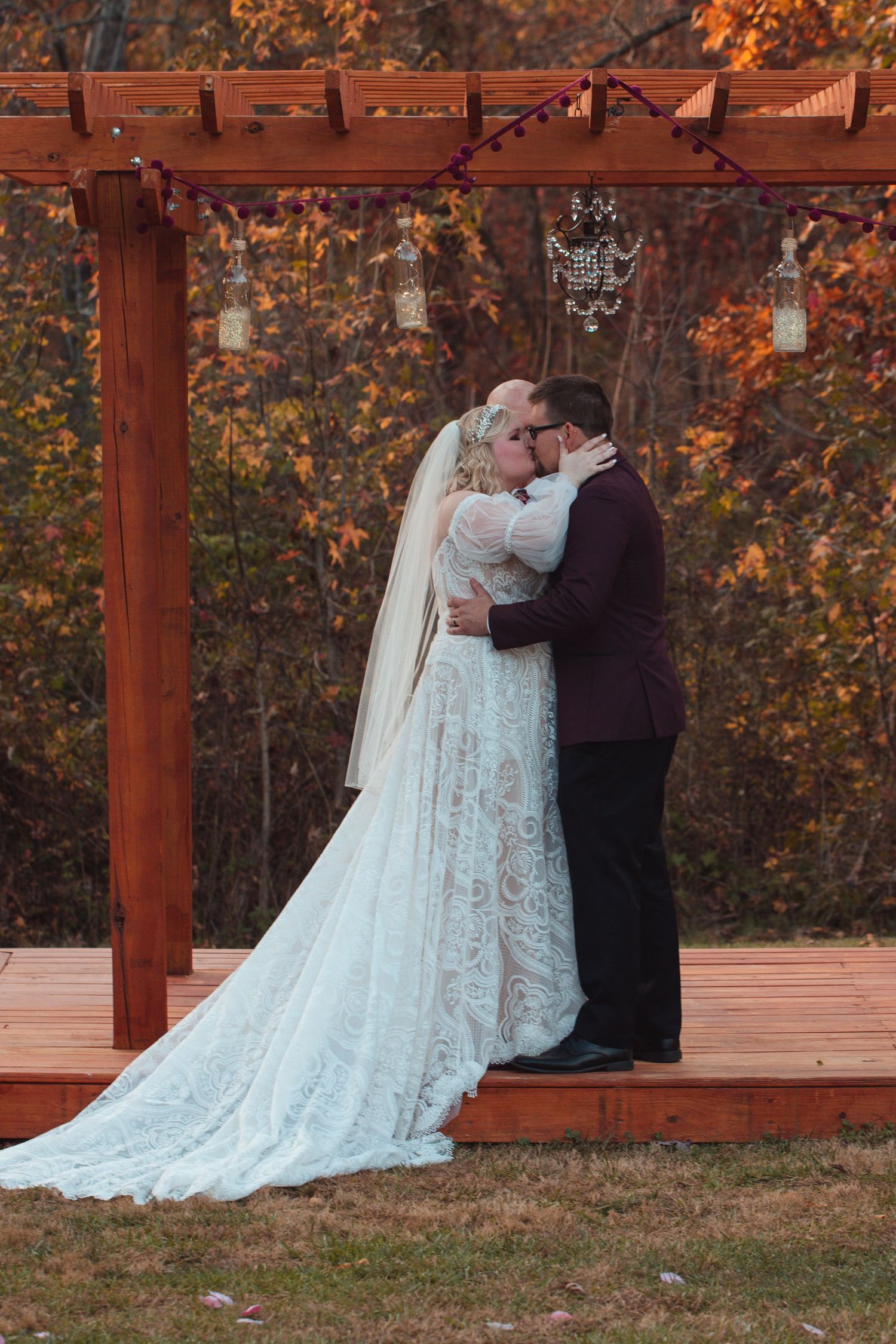 Bride and groom embracing at the altar of an outdoor wedding