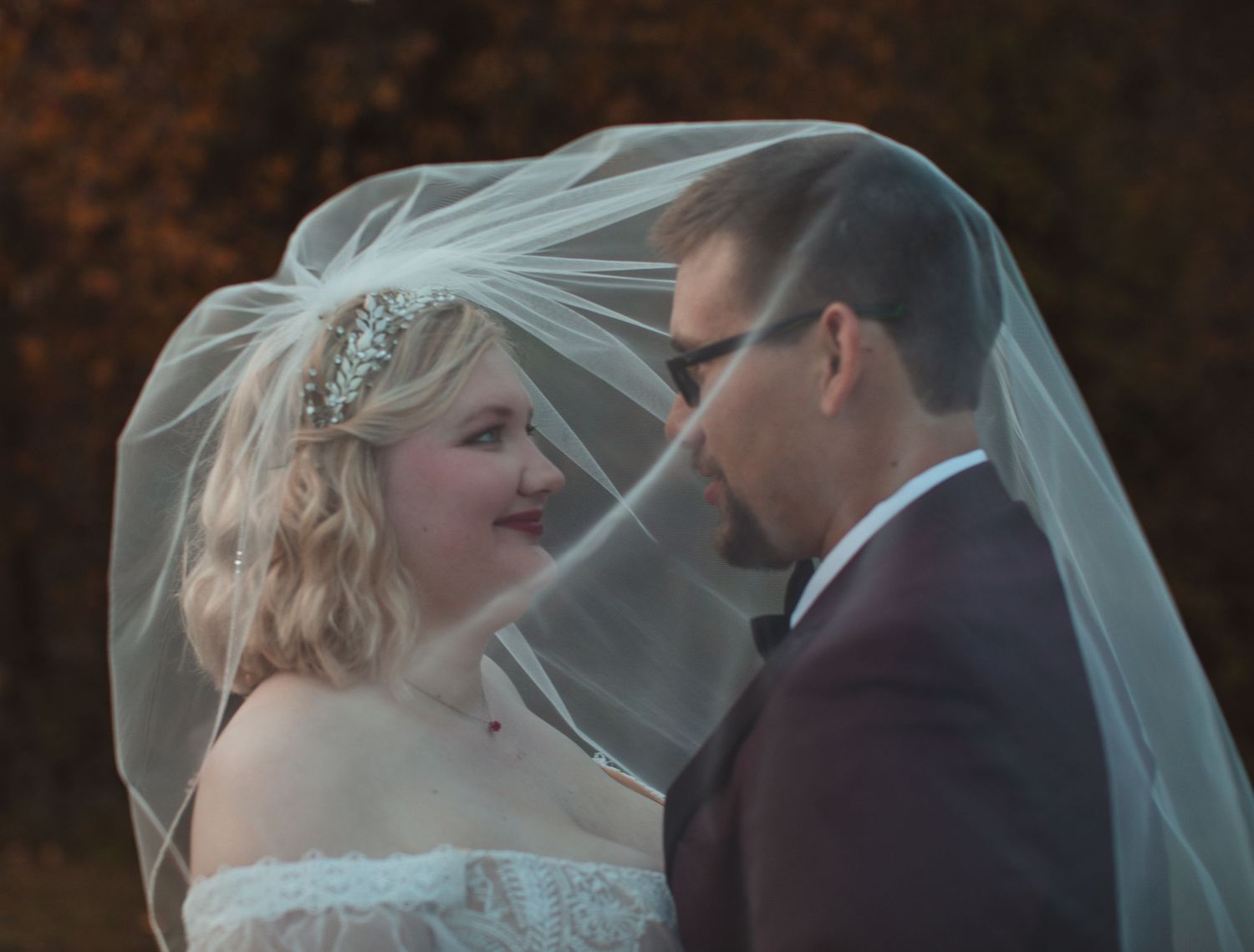 Bride and groom sharing a quiet moment under her veil