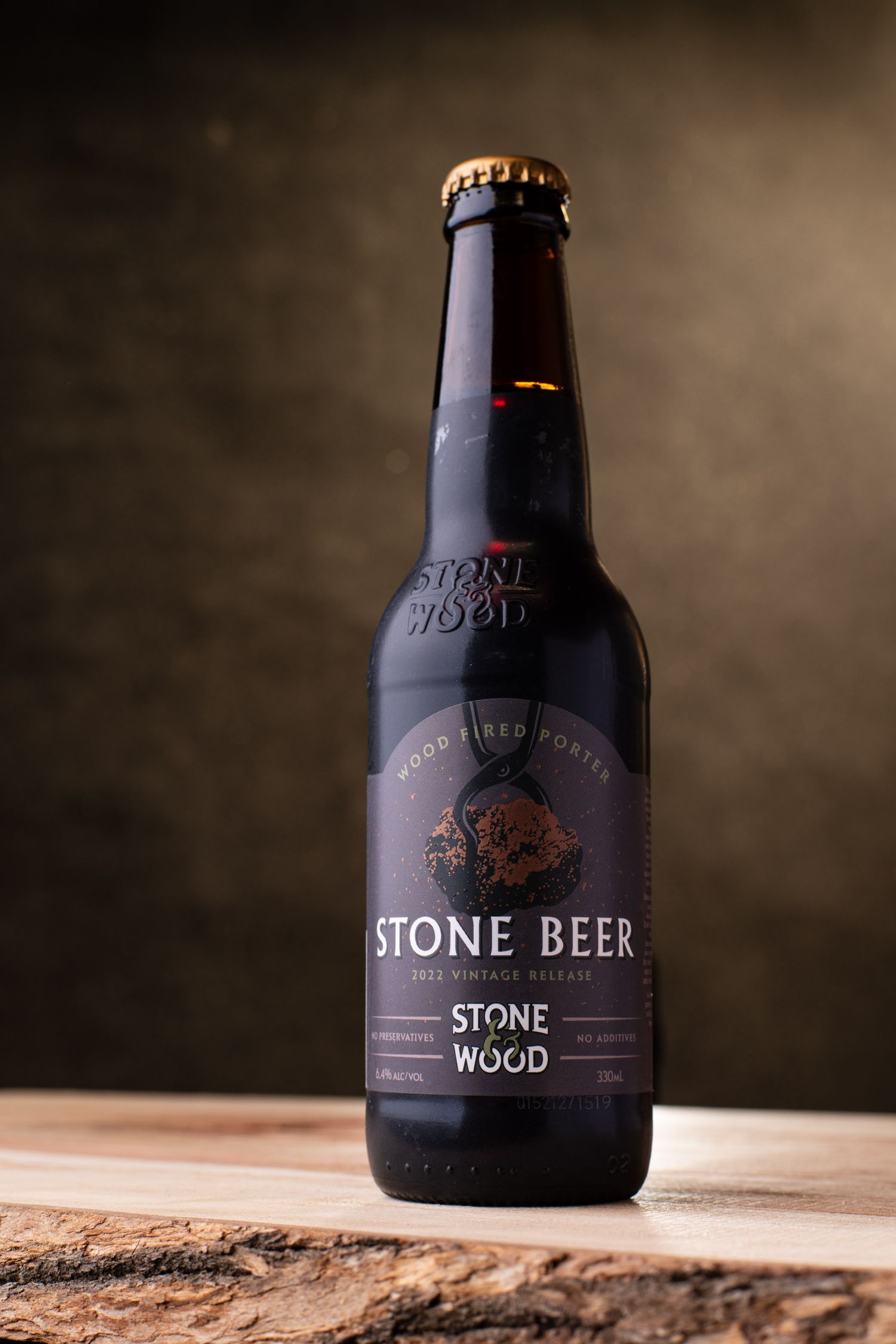 Stone Beer Wood Fired Porter bottle by Stone & Wood brewery, 2012 vintage release on wooden surface.