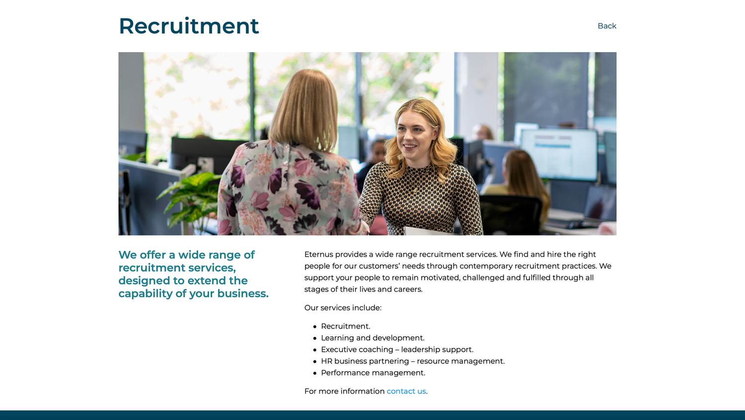 Two women smiling in a bright office setting on a recruitment services webpage.