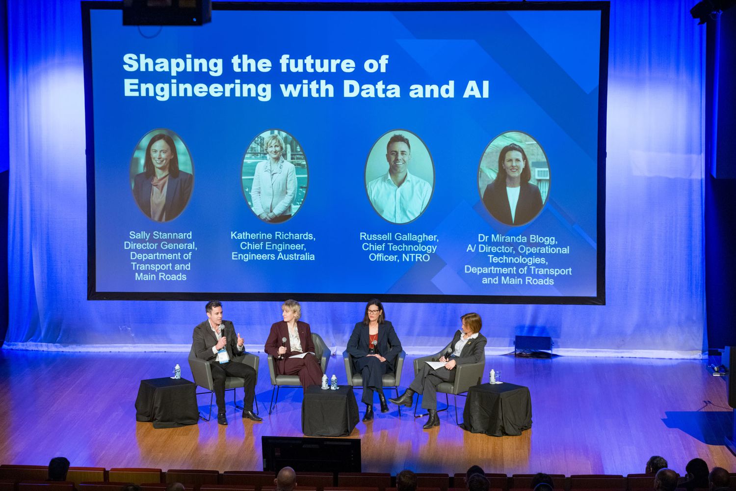 Four panelists discussing engineering future with Data and AI on conference stage.
