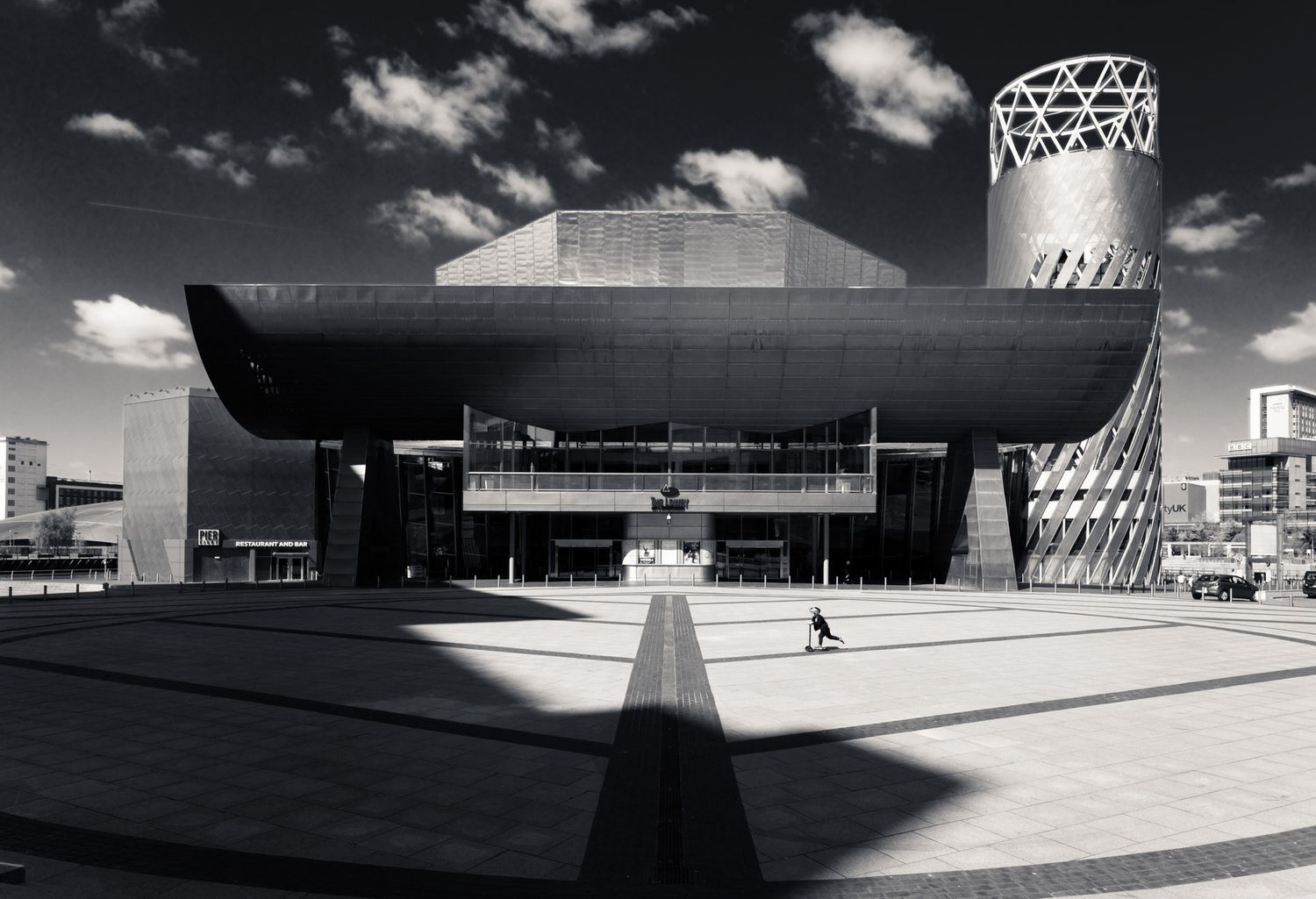 Black and white aerial view of the Lowry Theatre with bold angular architecture in Salford Quays.