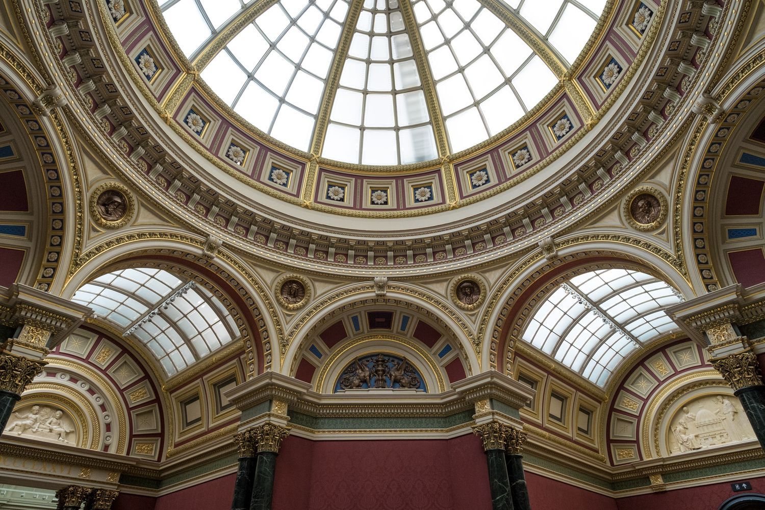 Ornate domed ceiling with stained glass skylight inside the National Gallery, London.
