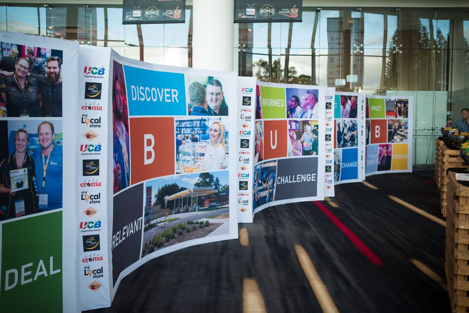 Promotional banners displayed at an indoor event venue.