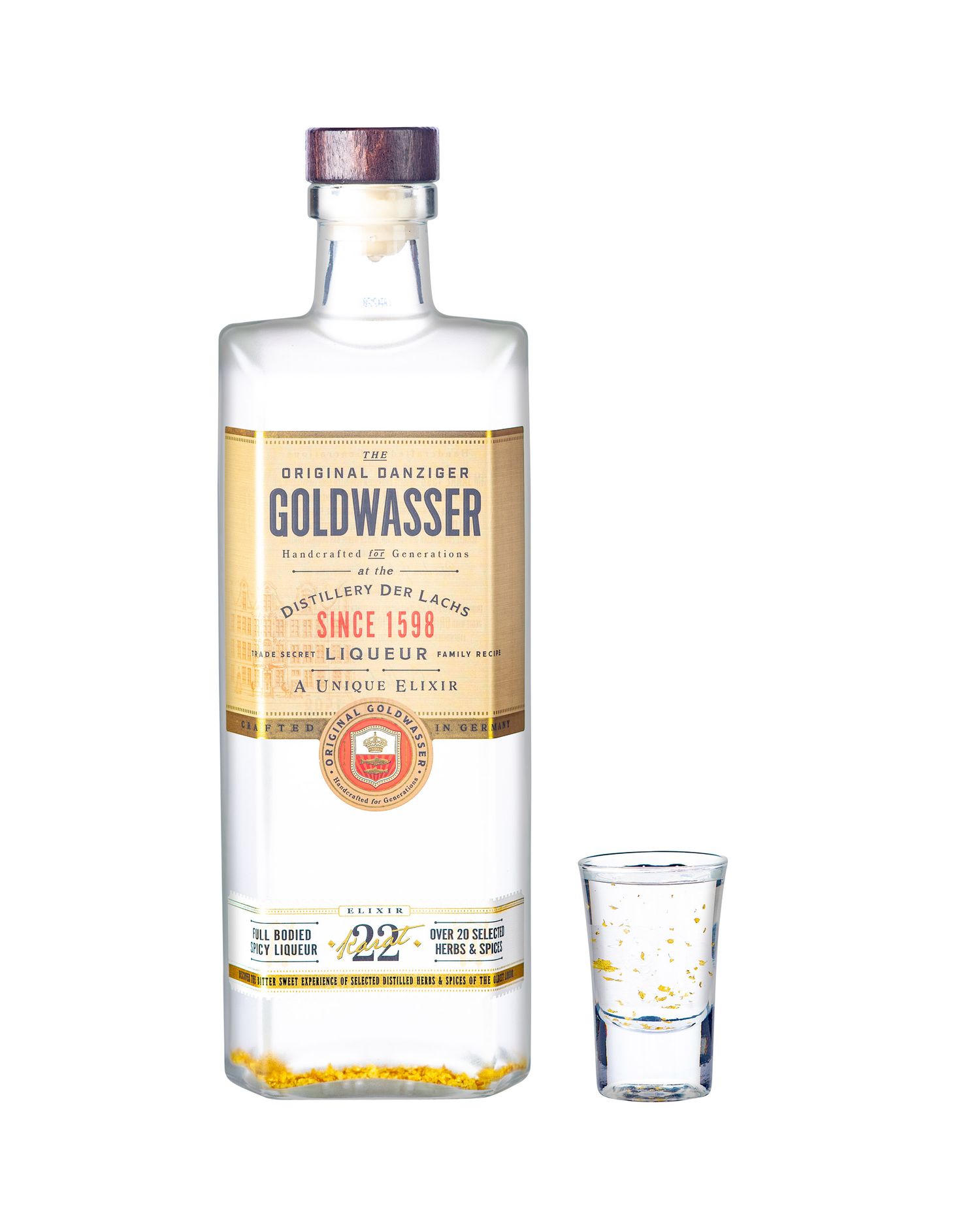 Original Danziger Goldwasser gold flake liqueur bottle since 1598 with small shot glass beside it.