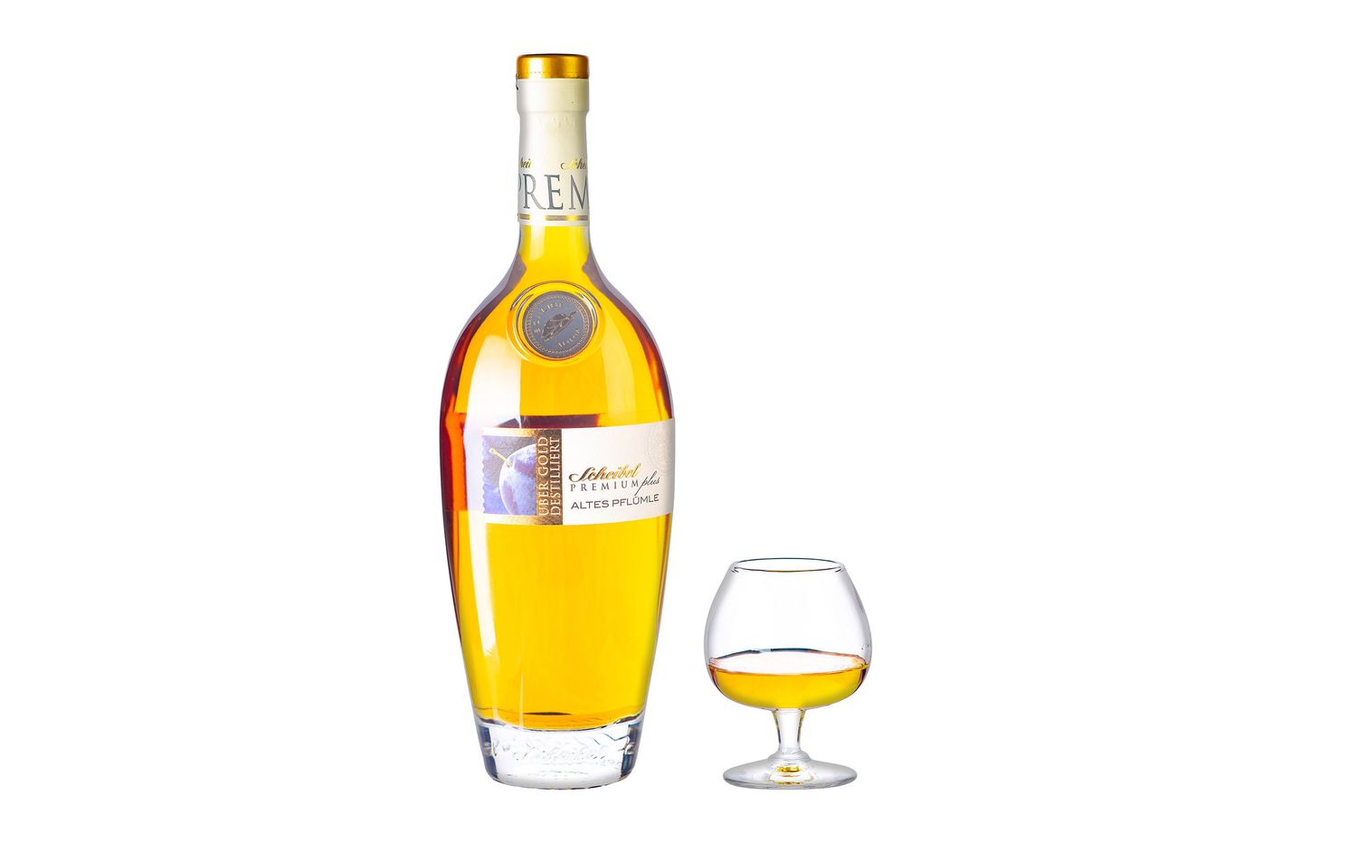 Elegant tall cognac bottle with golden label beside a classic brandy snifter glass with amber spirit.