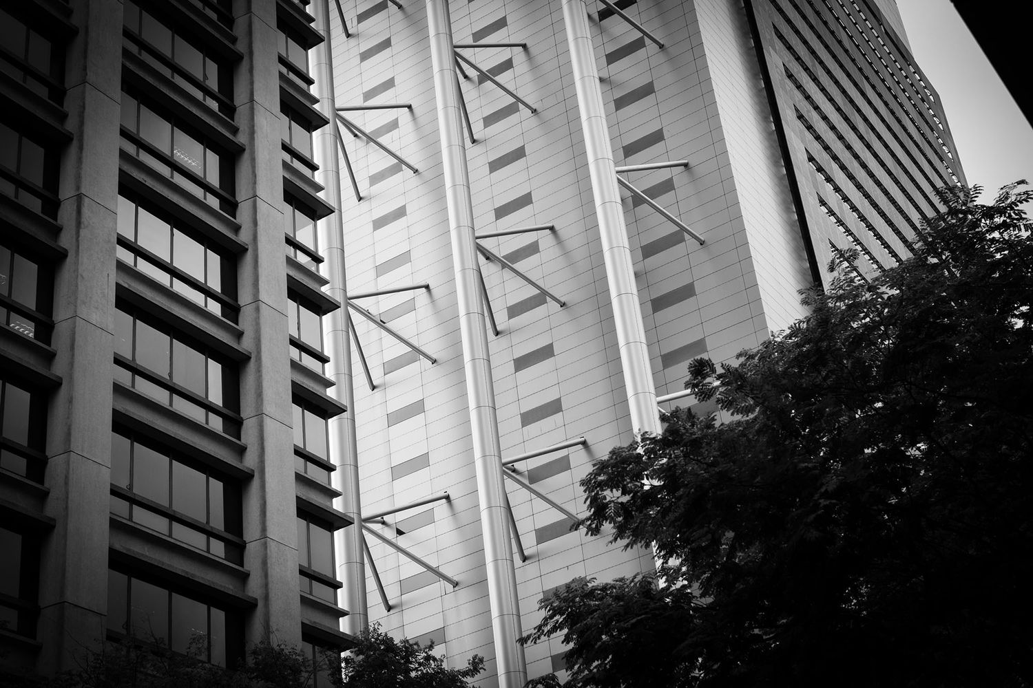 Black and white close-up of a modern skyscraper facade with geometric steel cross-brace details.