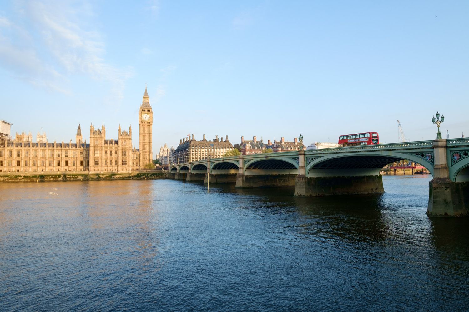 Westminster Bridge over the River Thames with Big Ben and Houses of Parliament, London, with a red double-decker bus.